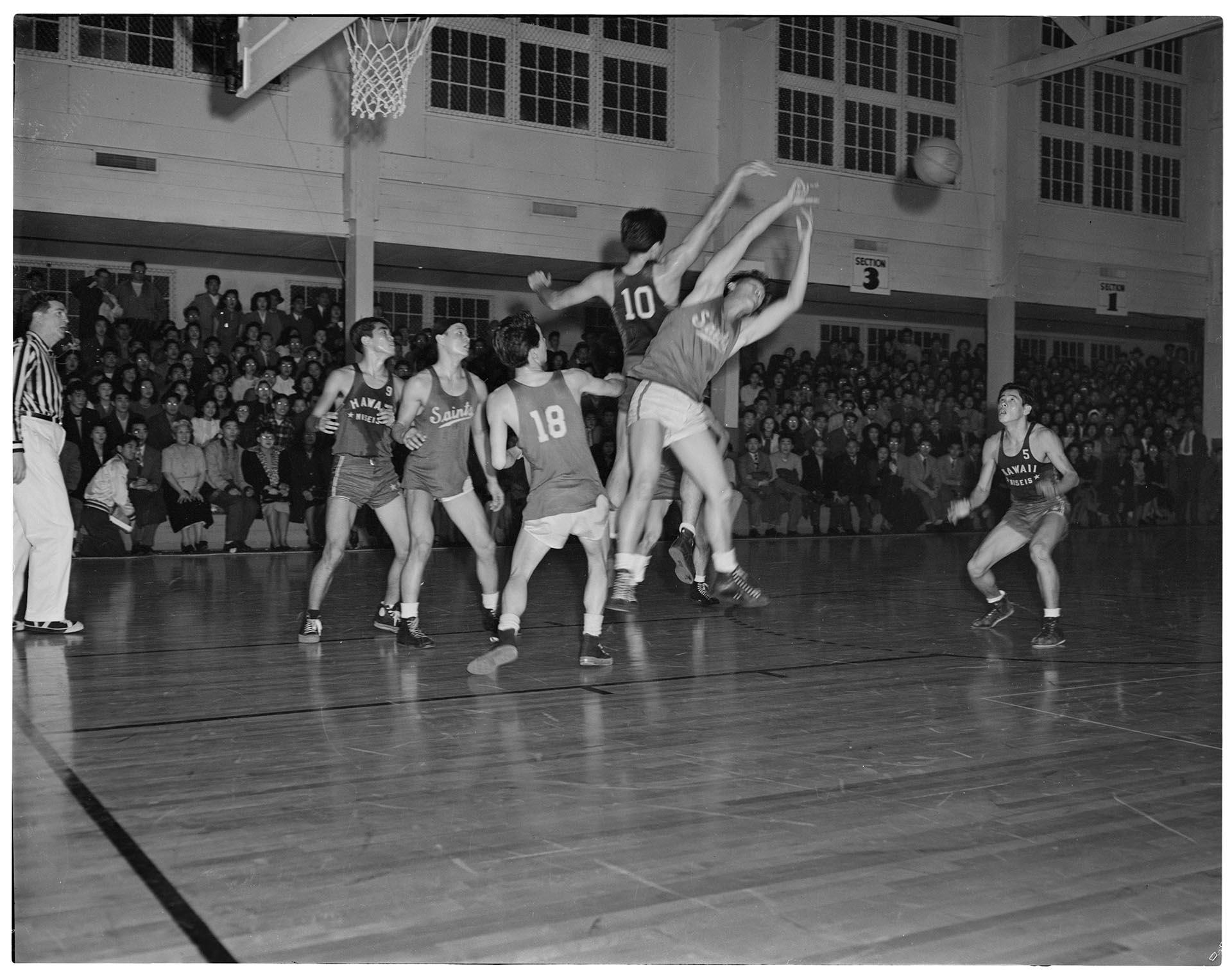 Image of Basketball players jumping for ball, Seattle, December 1948