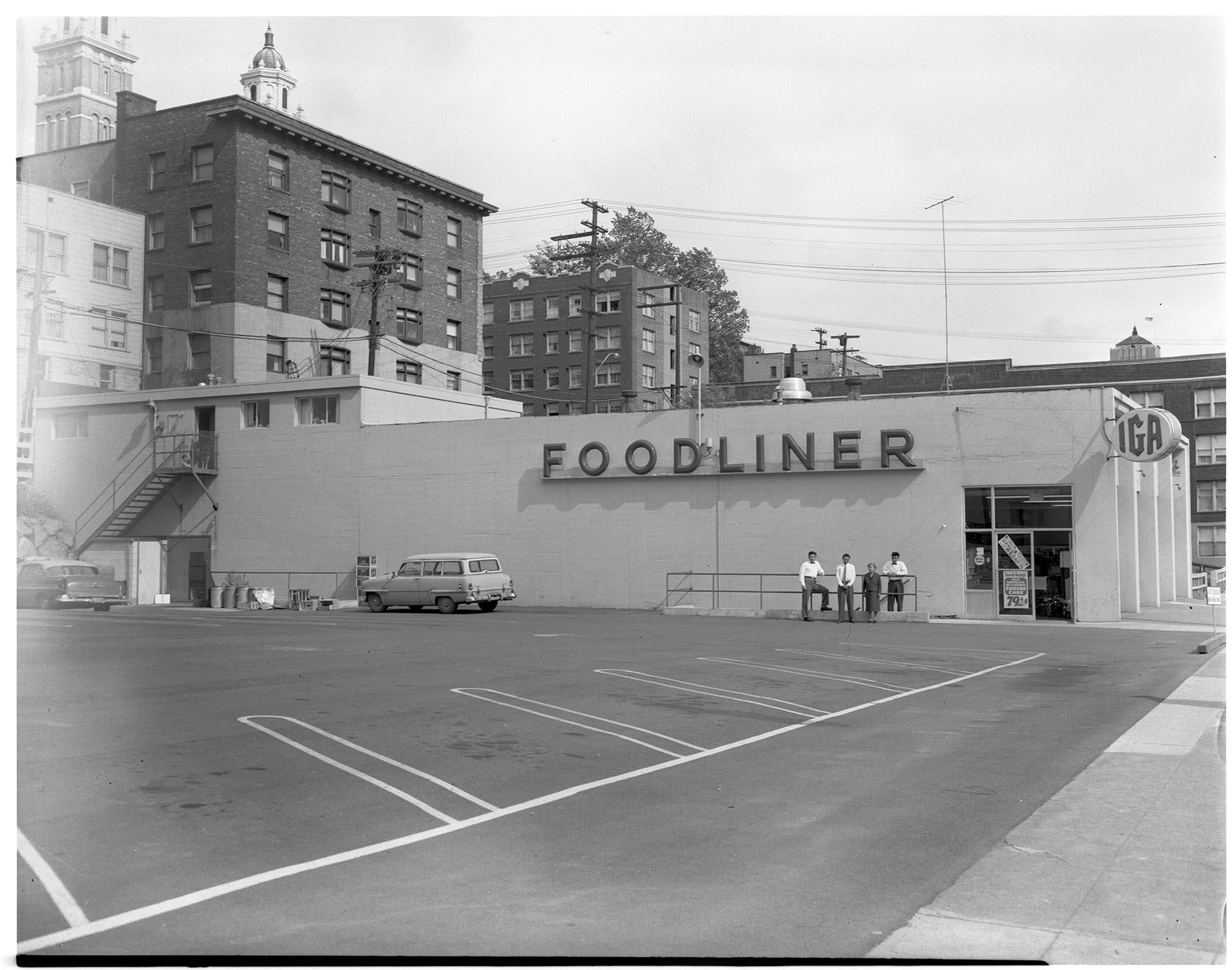 Image of Kimura family posing in front of their store, Seattle, circa 1953