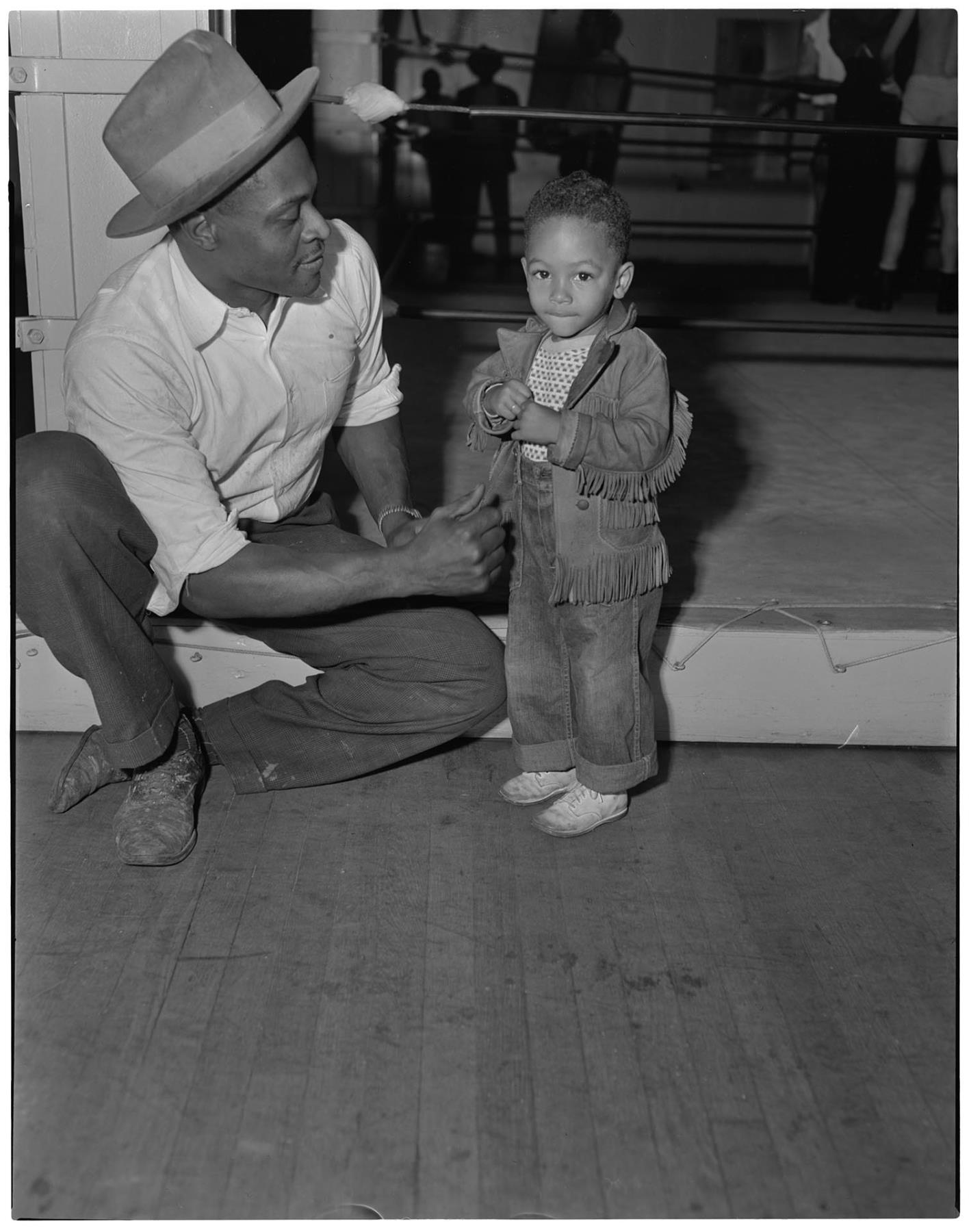 Image of Slick Adams sitting with a small boy, Seattle circa 1953