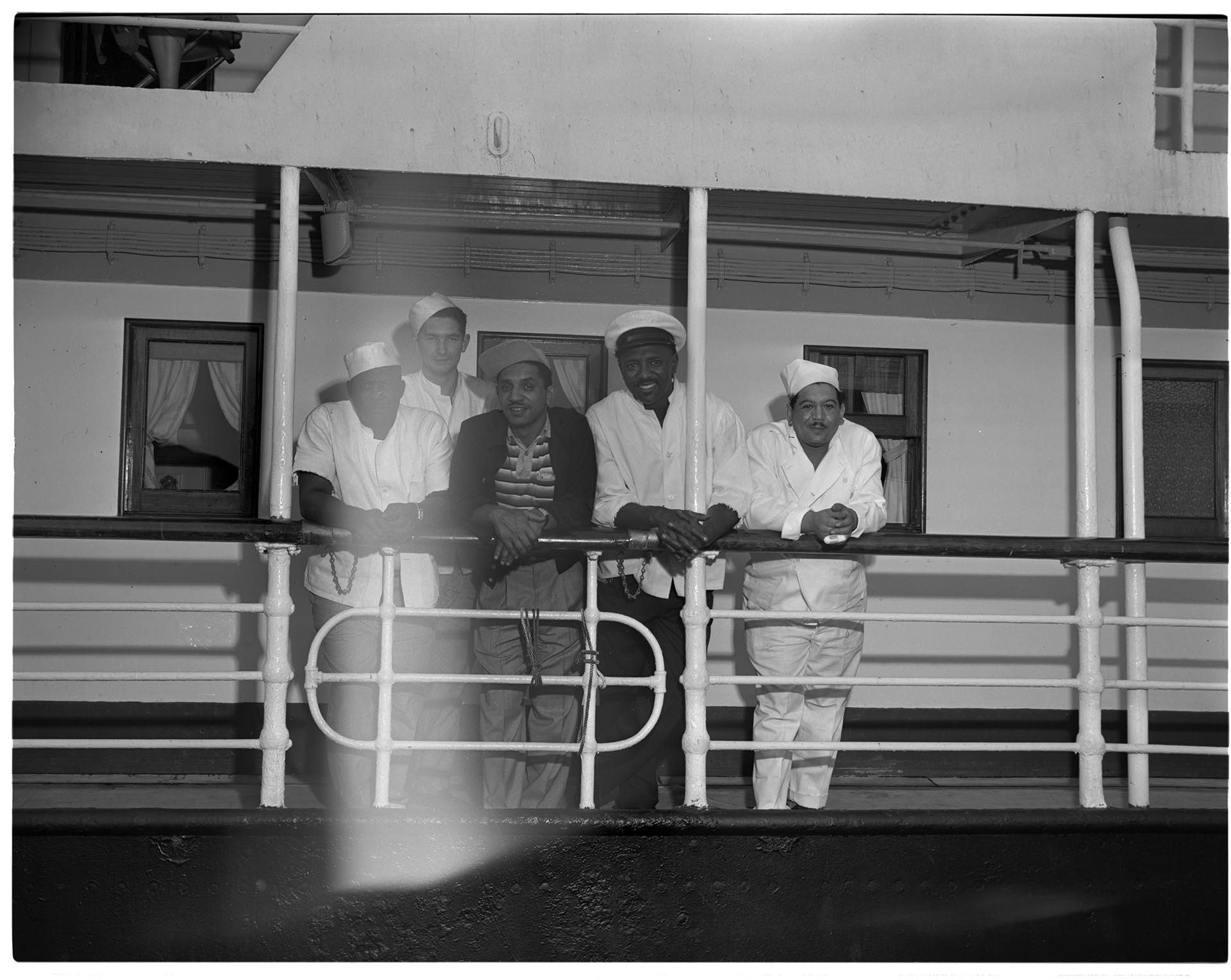 Image of Men standing at the rail of a ship, Seattle, circa 1953