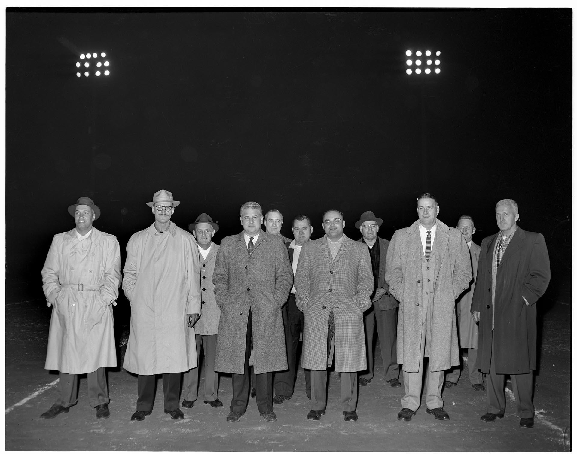Image of Men standing on football field at high school reunion, Seattle, circa 1953