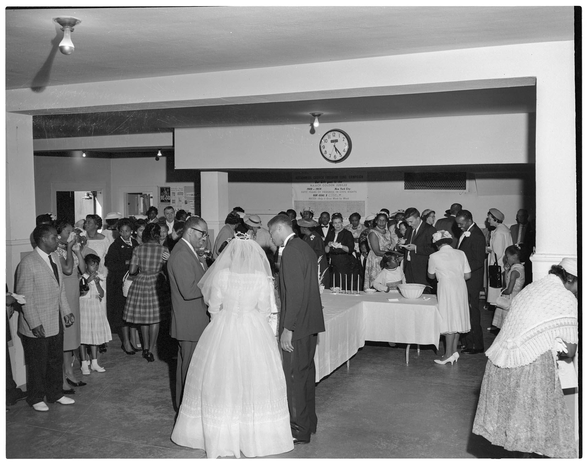 Image of Rev. McKinney speaking with newlyweds at wedding reception, Seattle, 1959
