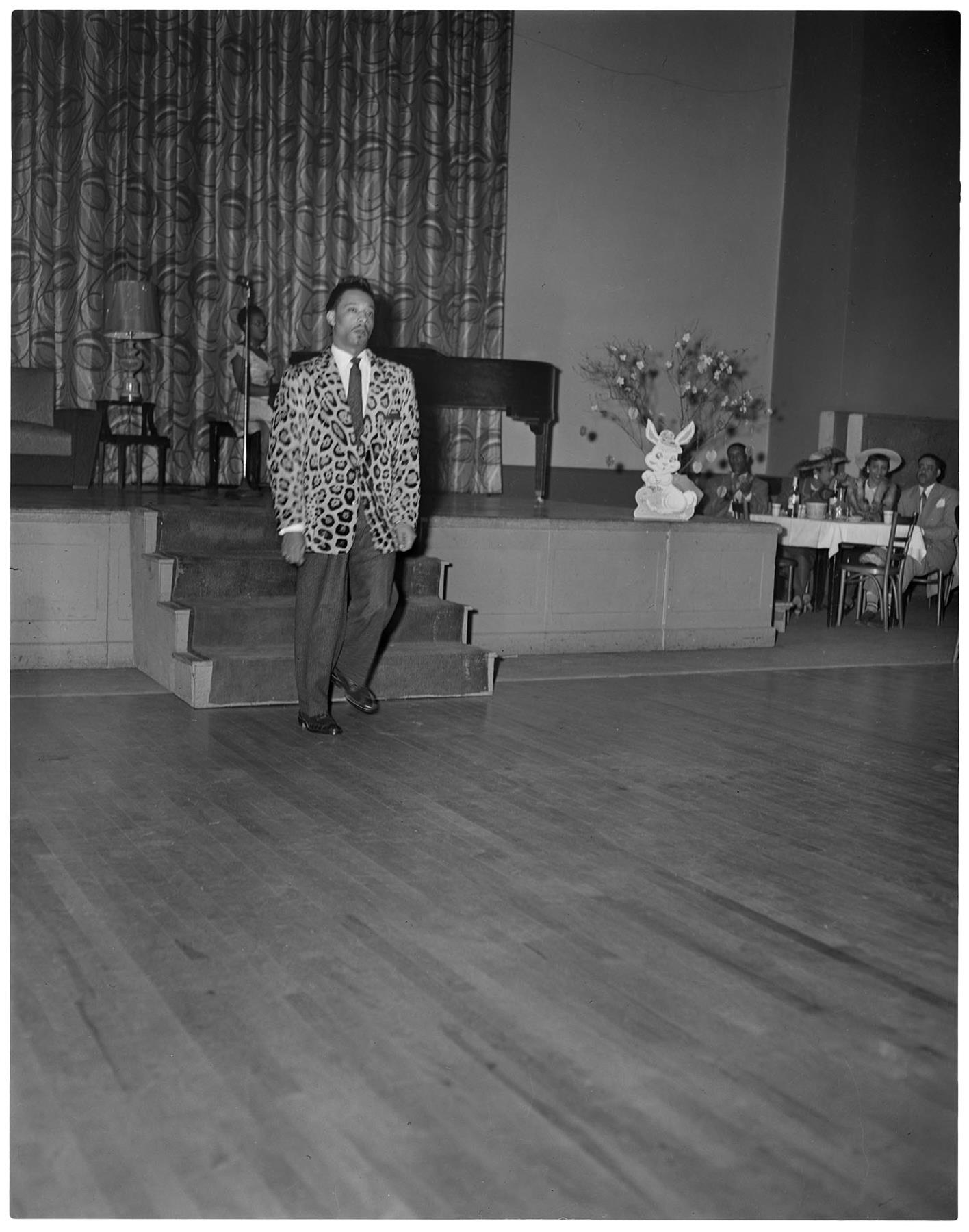 Image of Man modeling leopard print jacket at fashion show, Seattle, circa 1953