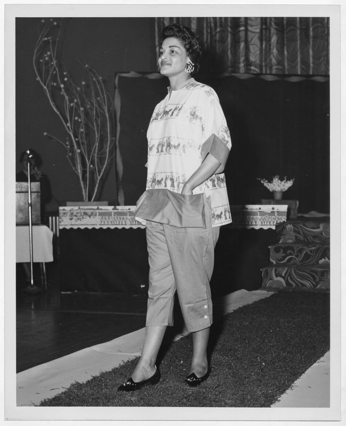 Image of Woman modeling outfit at fashion show, circa 1955