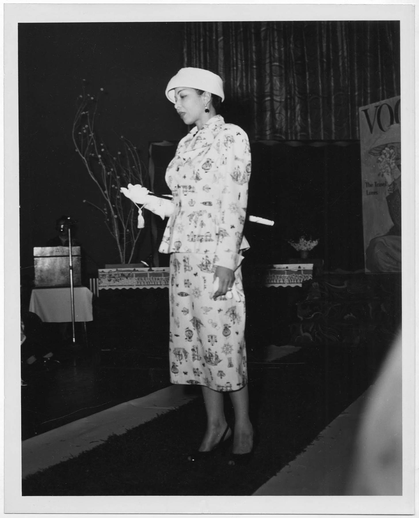Image of Woman modeling outfit at fashion show, circa 1955