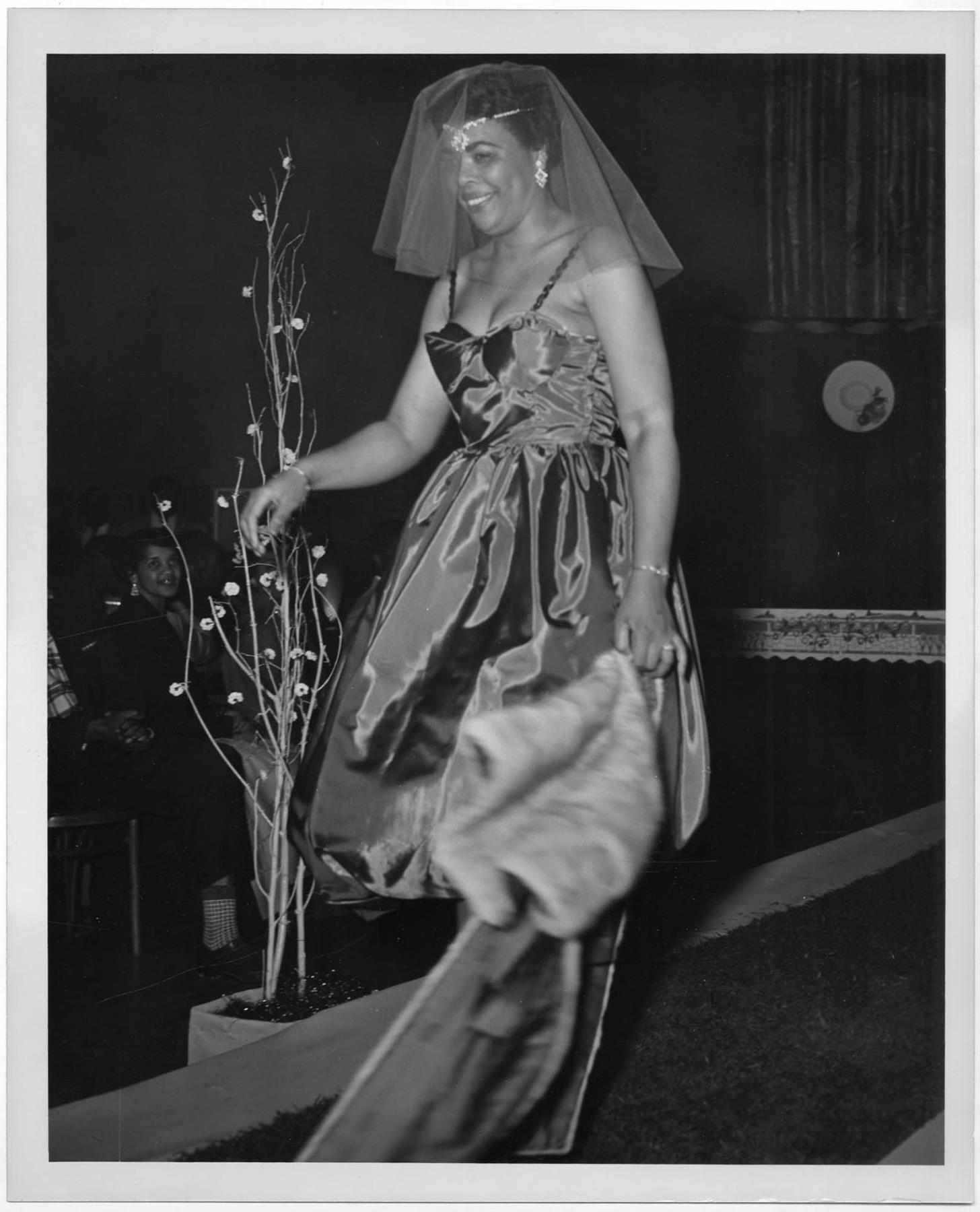 Image of Woman modeling dress at fashion show, circa 1955