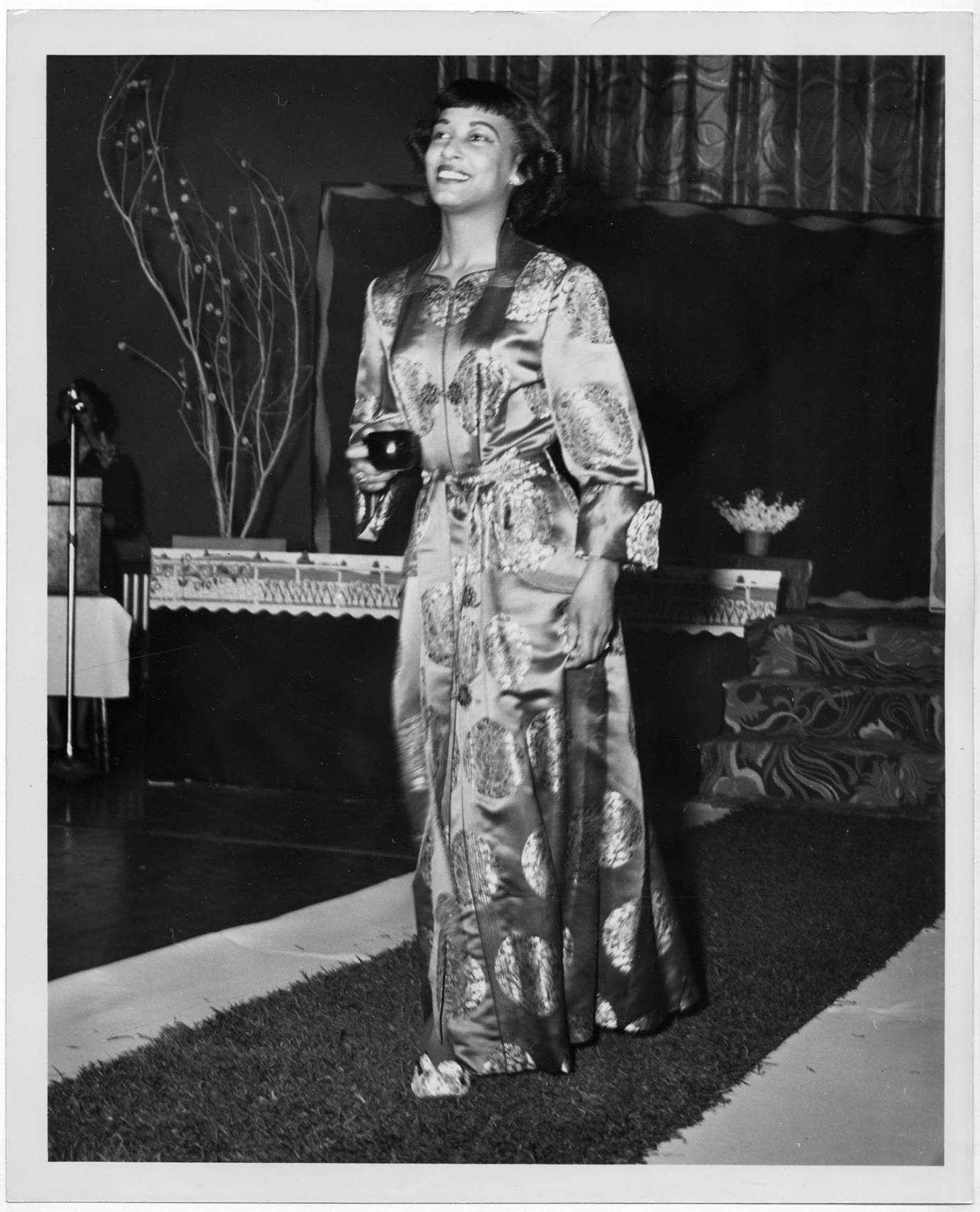 Image of Woman modeling robe at fashion show, circa 1955