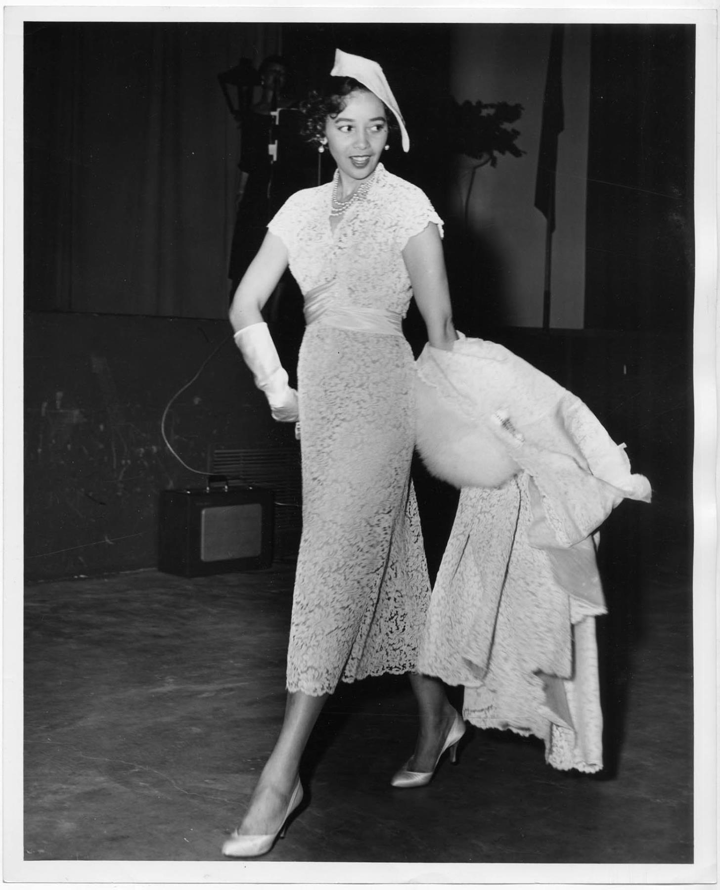 Woman modeling dress at fashion show, circa 1955 Museum of History & Industry Woman modeling dress at fashion show, circa 1955 Museum of History & Industry