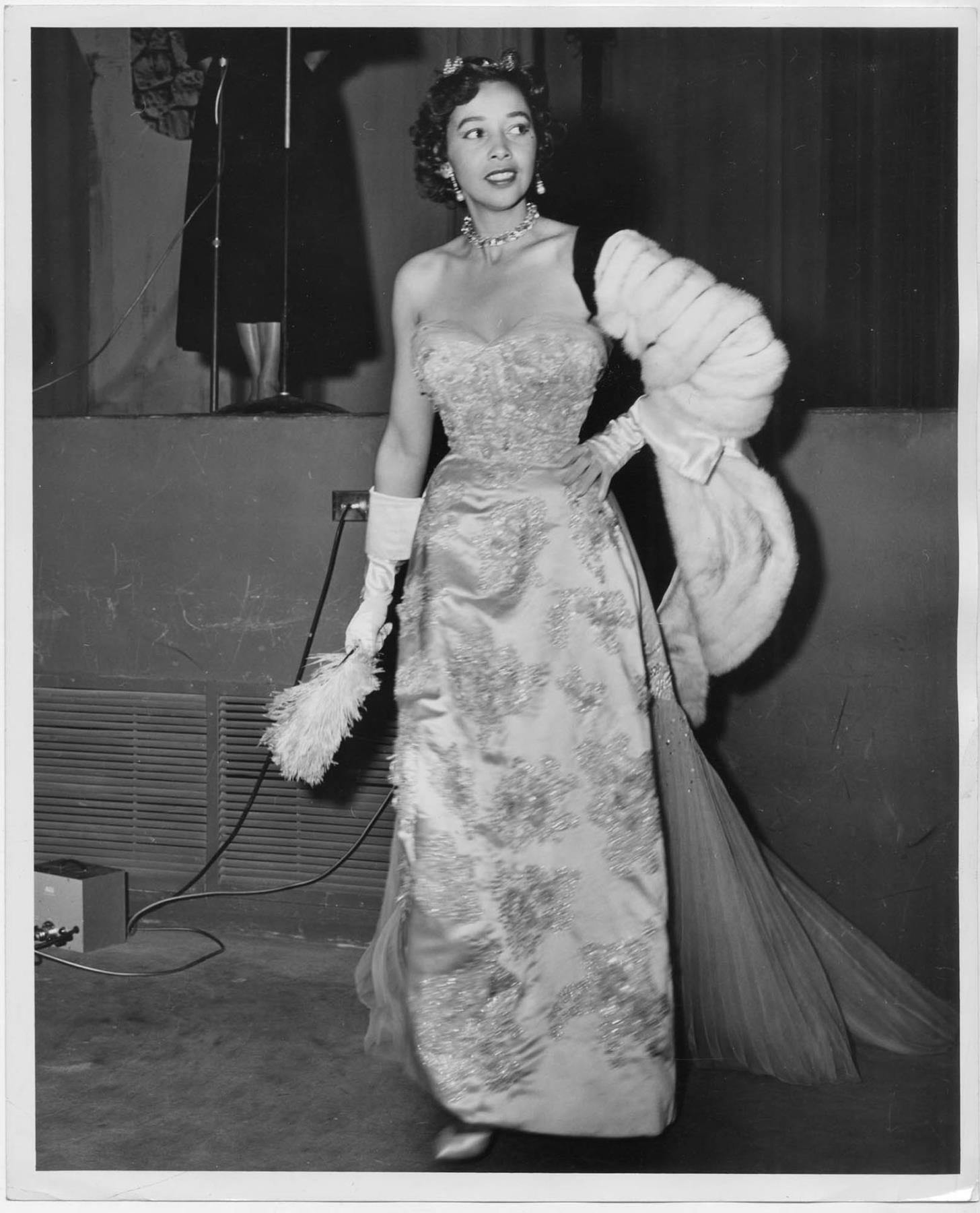 Image of Woman modeling dress at fashion show, circa 1955