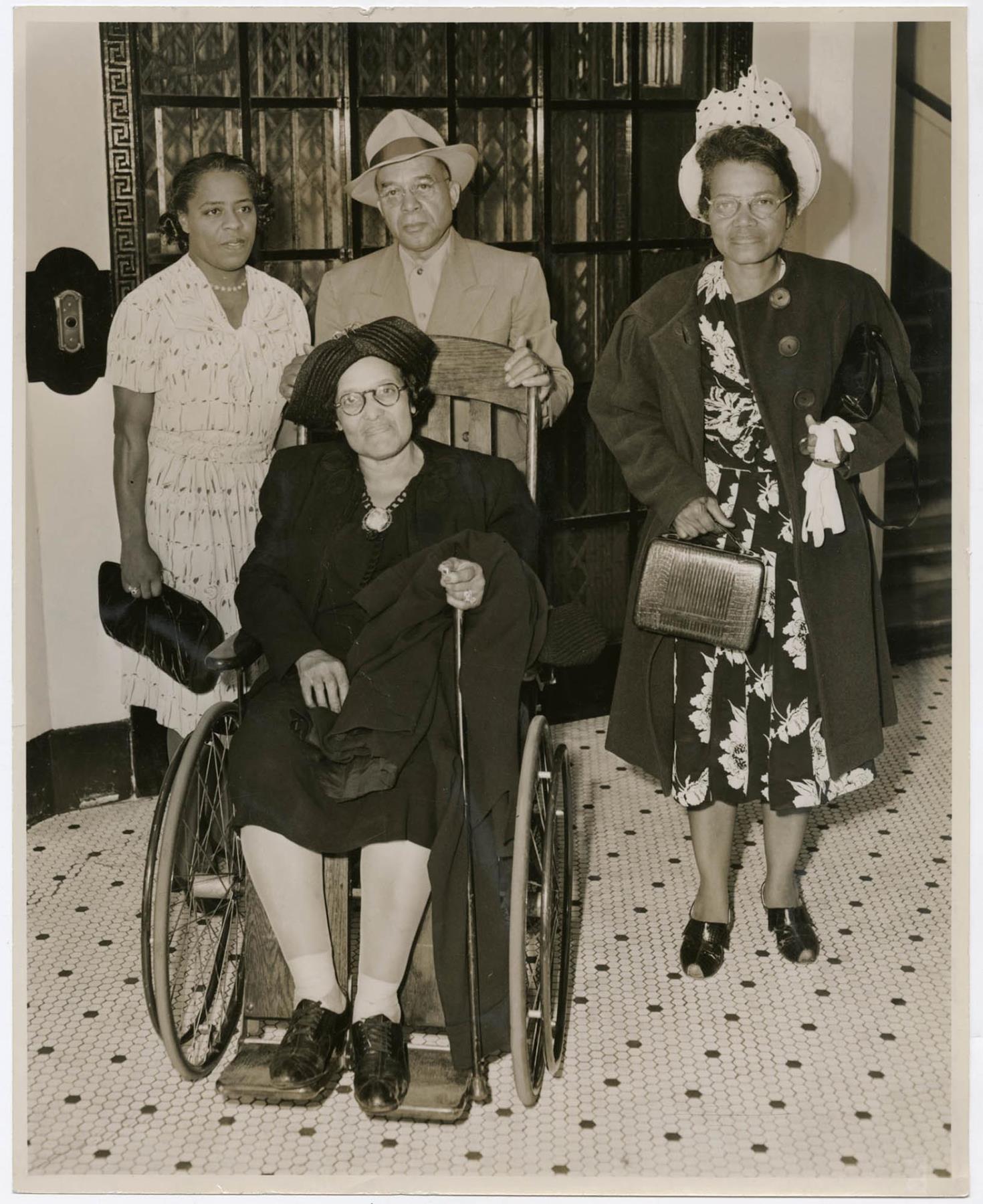 Image of Group of four people at King Street Station, Seattle, circa 1955
