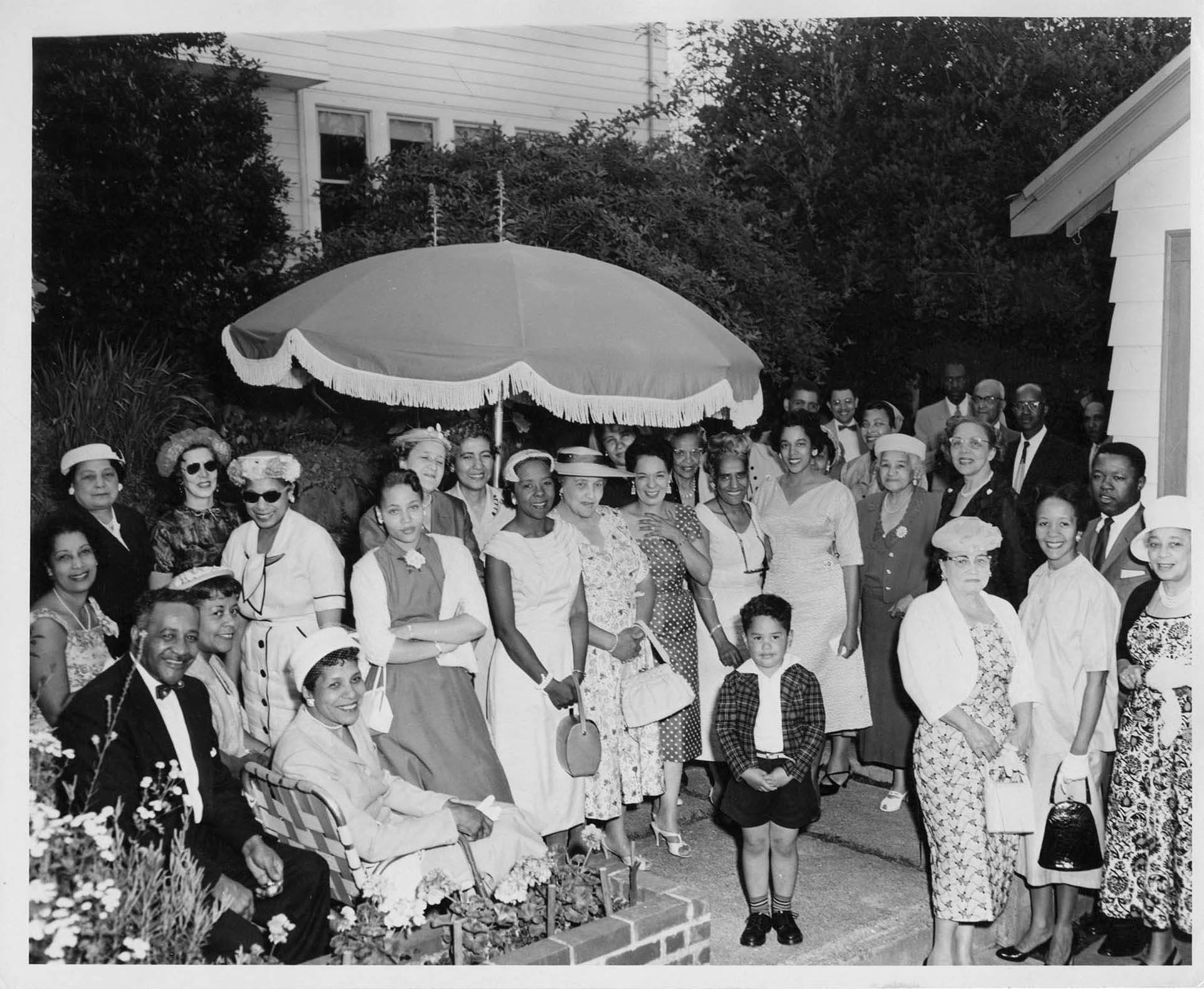 Image of Group of people posed in a backyard, circa 1955