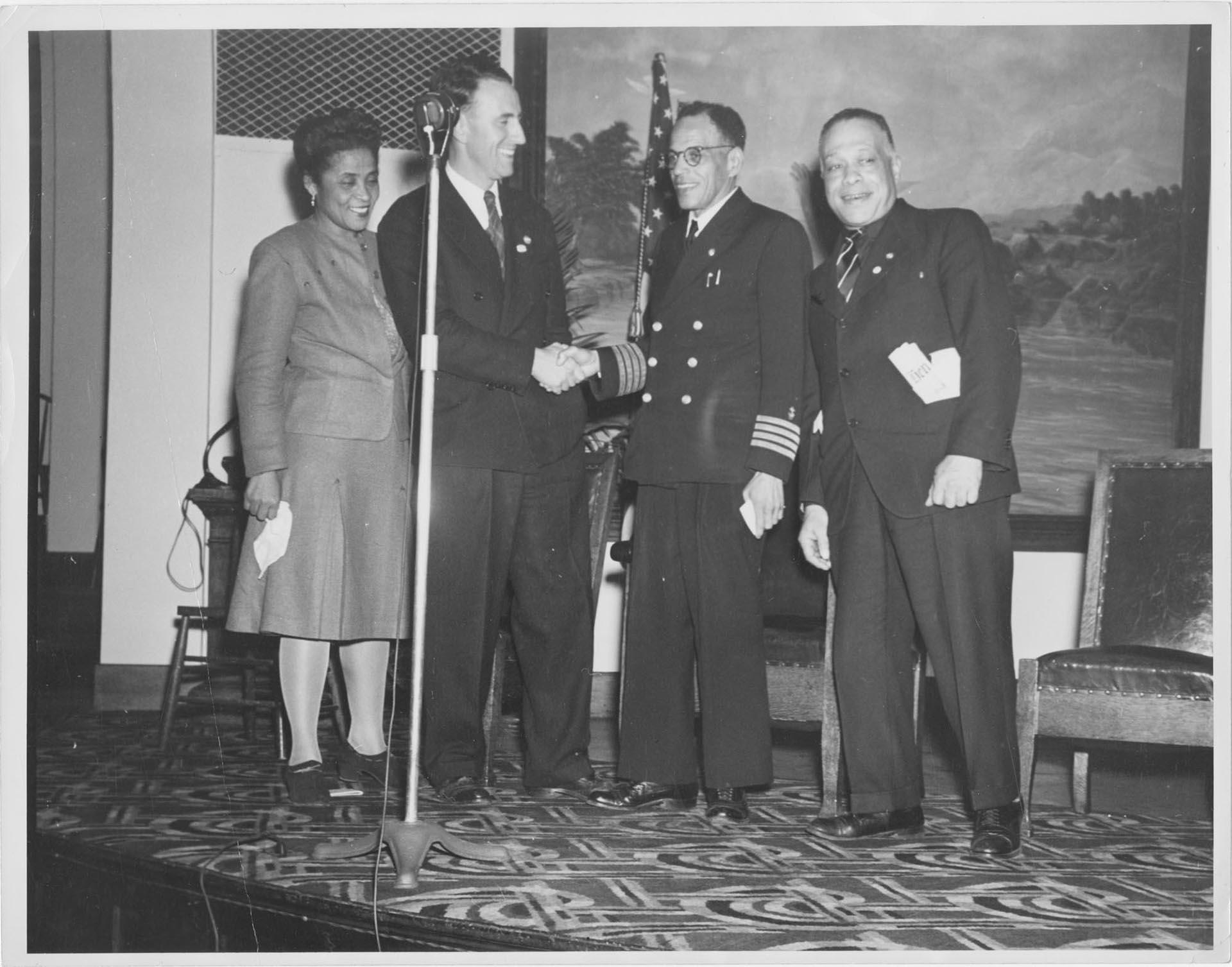 Image of Woman and three men celebrating at Mount Zion Baptist Church, Seattle, October 14, 1944