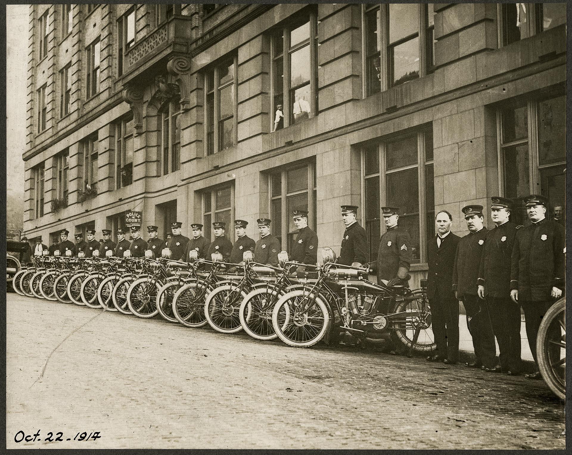 Image of Motorcycle police squad outside station, Seattle, October 22, 1914