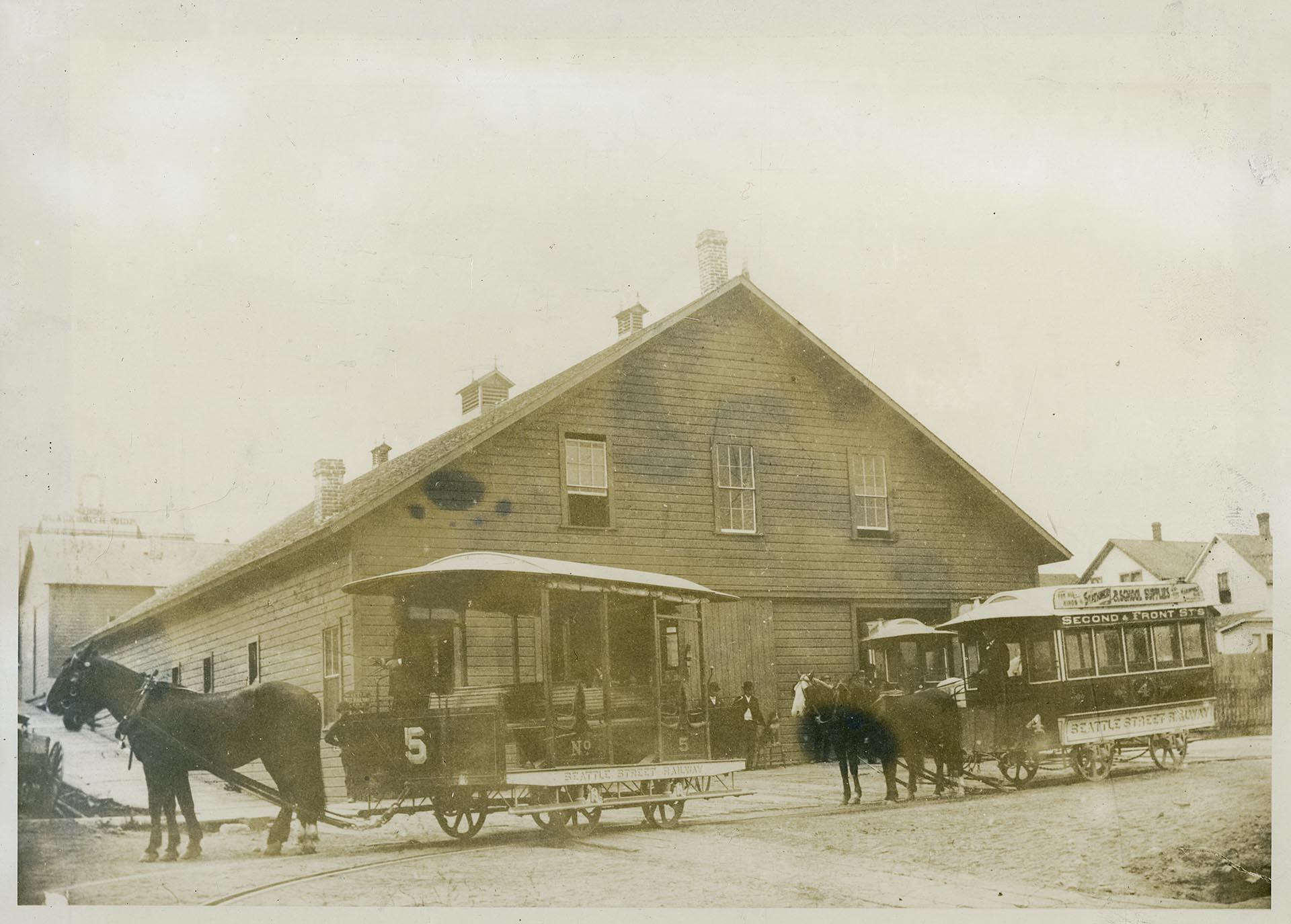 Image of Trolley car and horse barn, Seattle, circa 1886