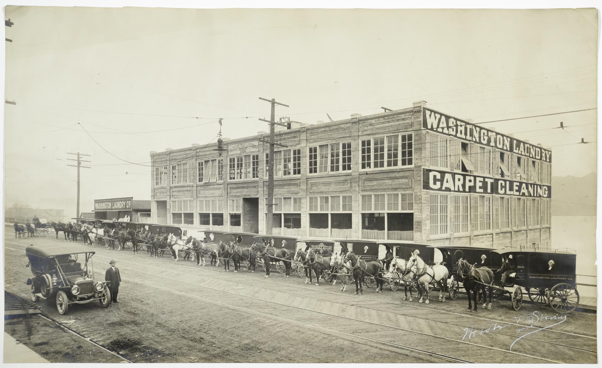 Image of Washington Laundry building and delivery carriages, Seattle, 1910