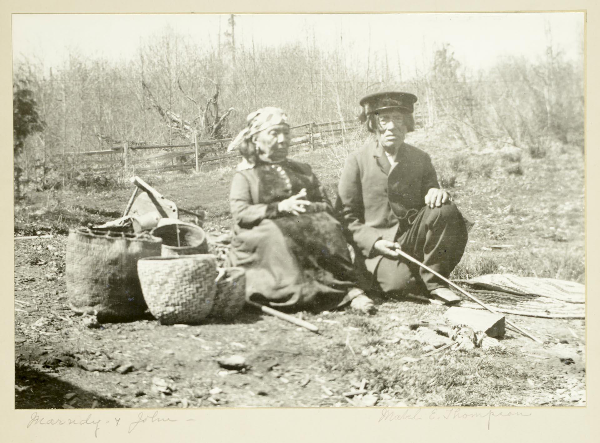 Image of Chesheeahud and Tleebuleetsa near campfire, circa 1900