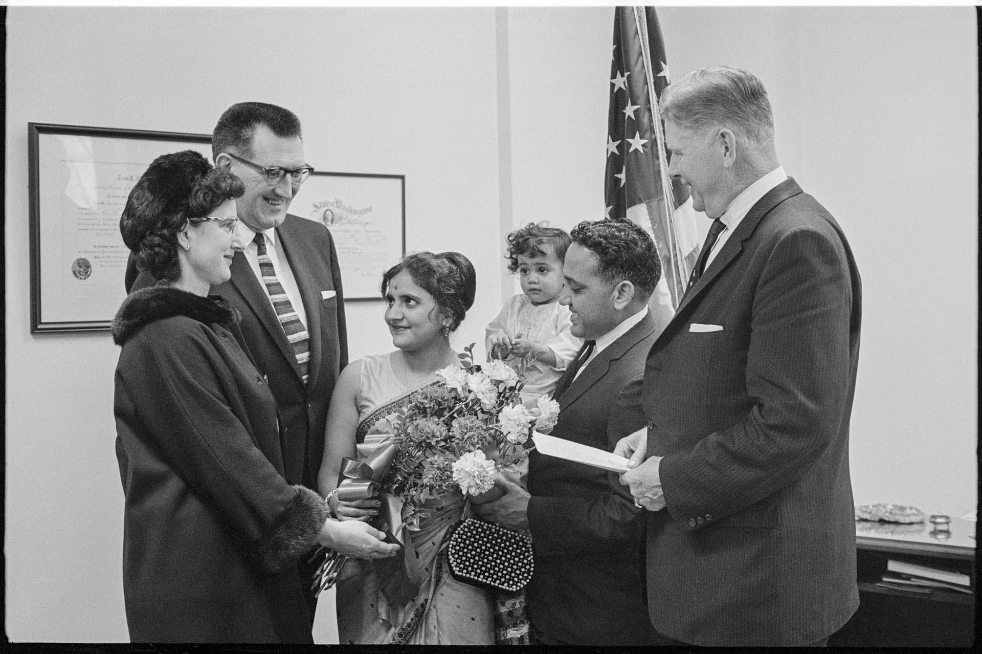 Image of Suman Gupta and family in office after she received permanent residency,  March, 1966