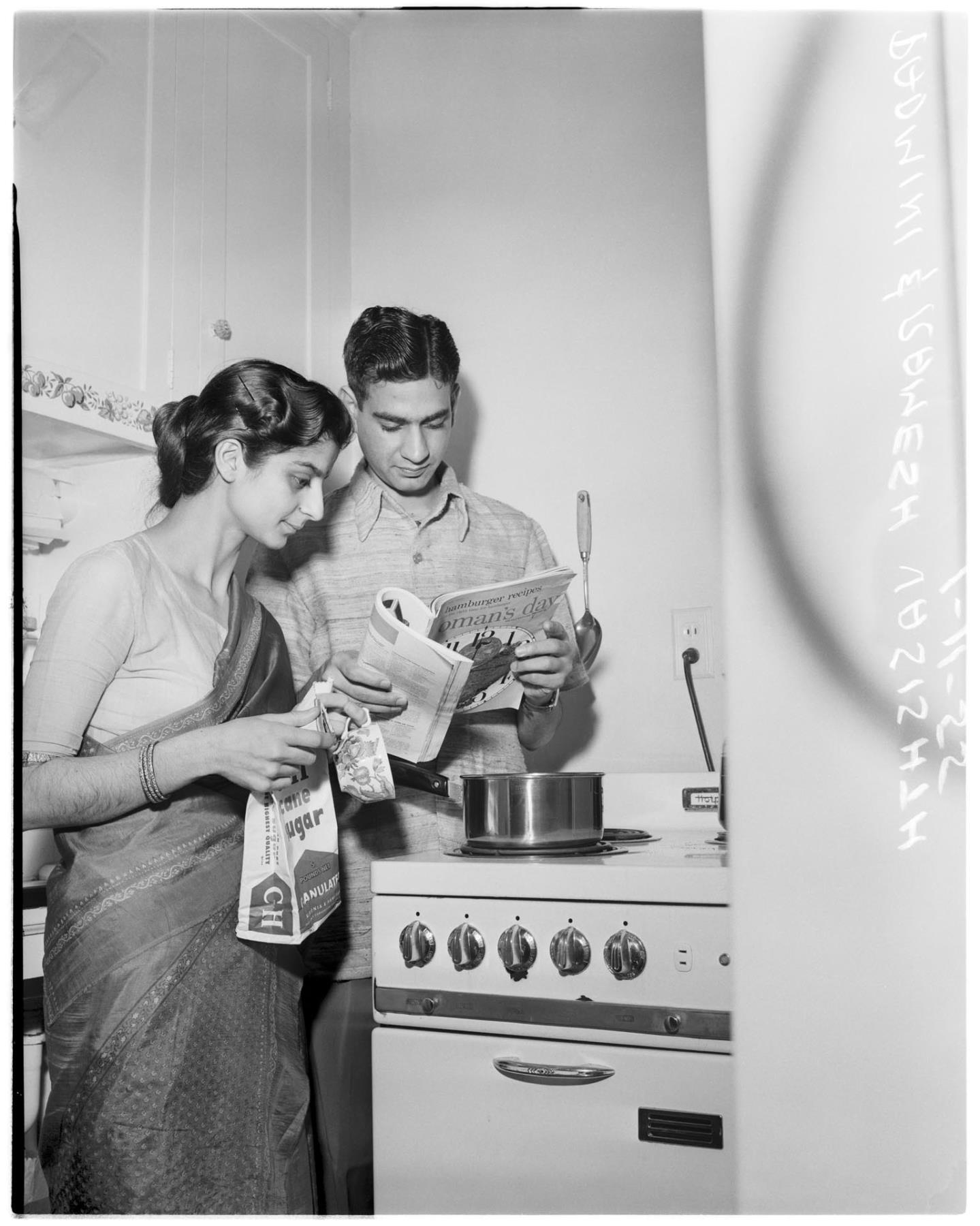 Image of Padmini Vasishth and her husband in their kitchen, January 11, 1955