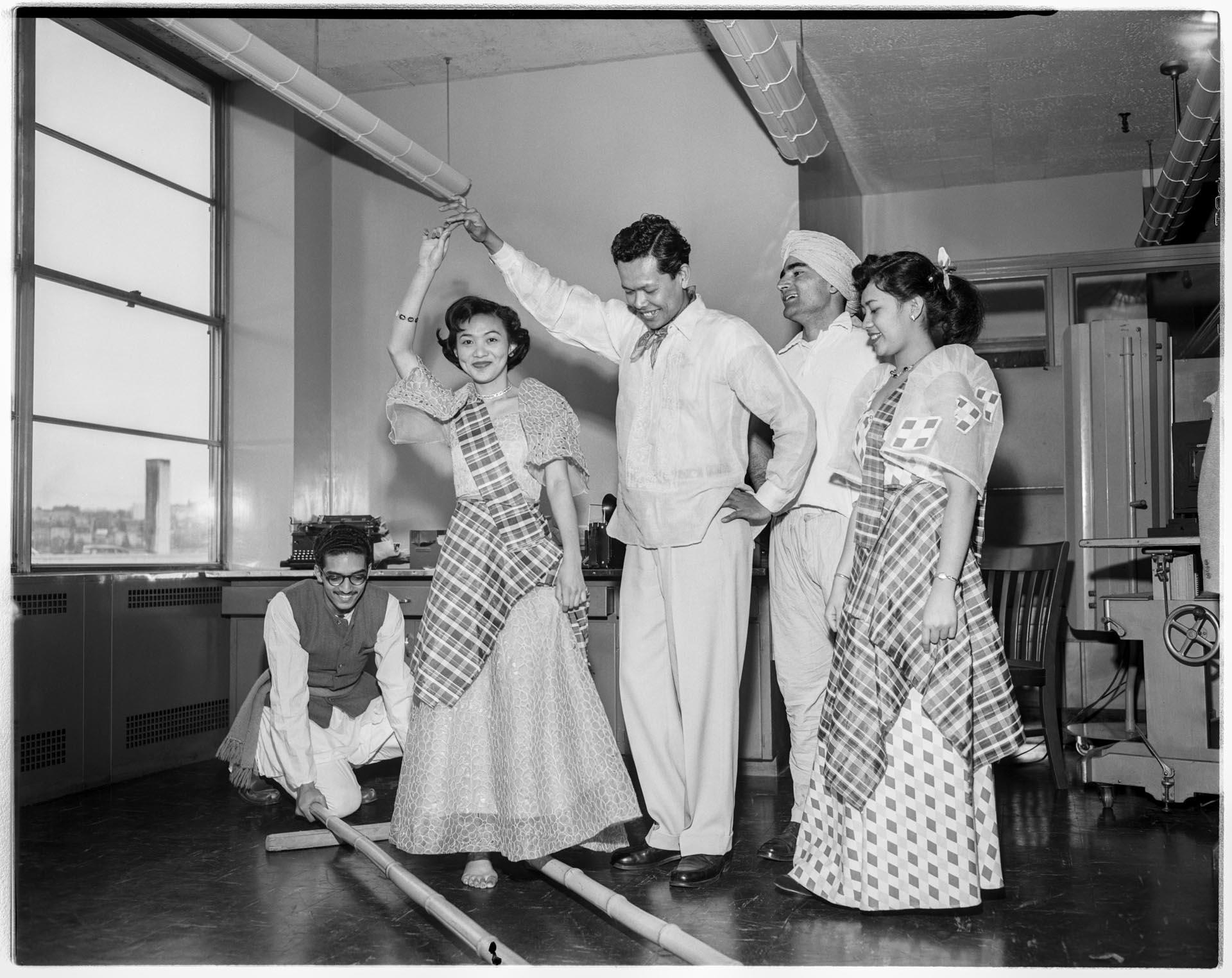 Image of Group of UW students demonstrating stick dance, April 1954