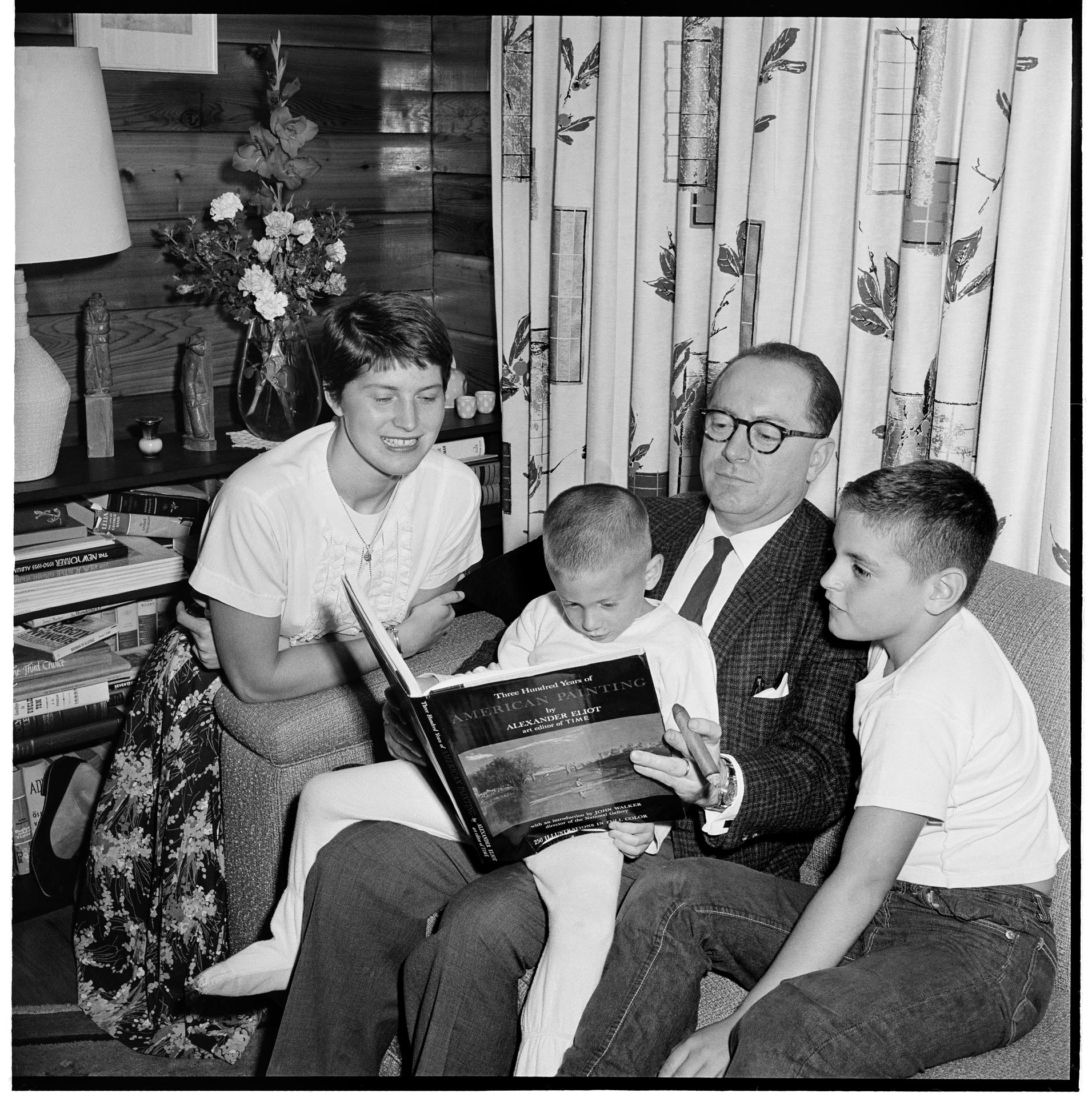 Image of Suzie Ordogh reading with her guardian family, Seattle, September 17, 1959