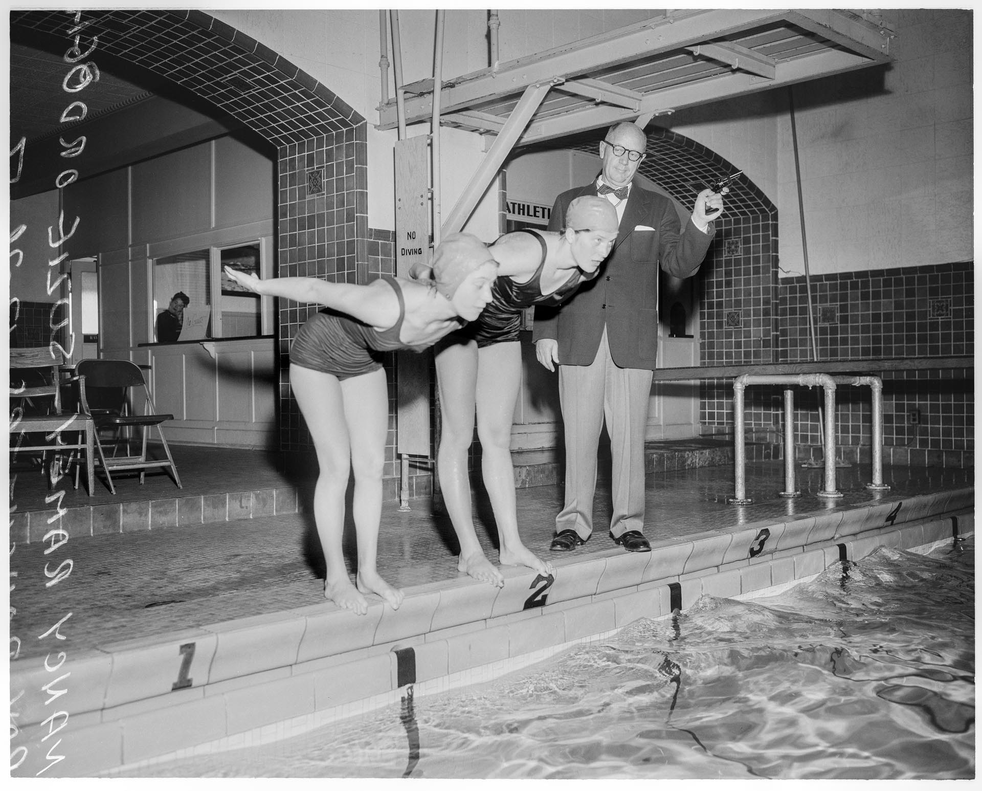 Image of Nancy Ramey and Suzie Ordogh racing for coach Ray Daughters at WAC, Seattle December 1956