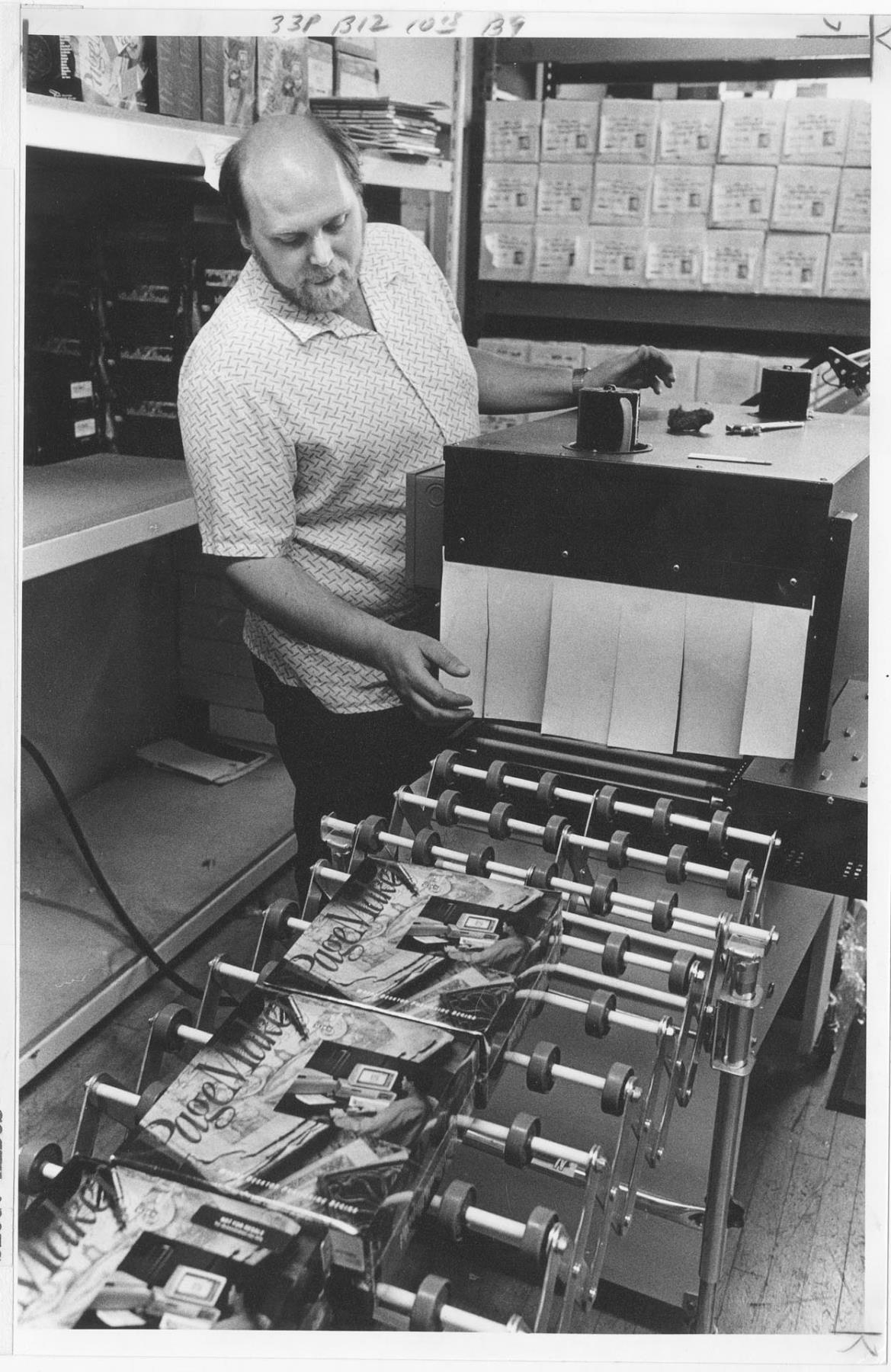 Image of Production worker Steve Taylor at Aldus checking packages of PageMaker, June 1, 1987