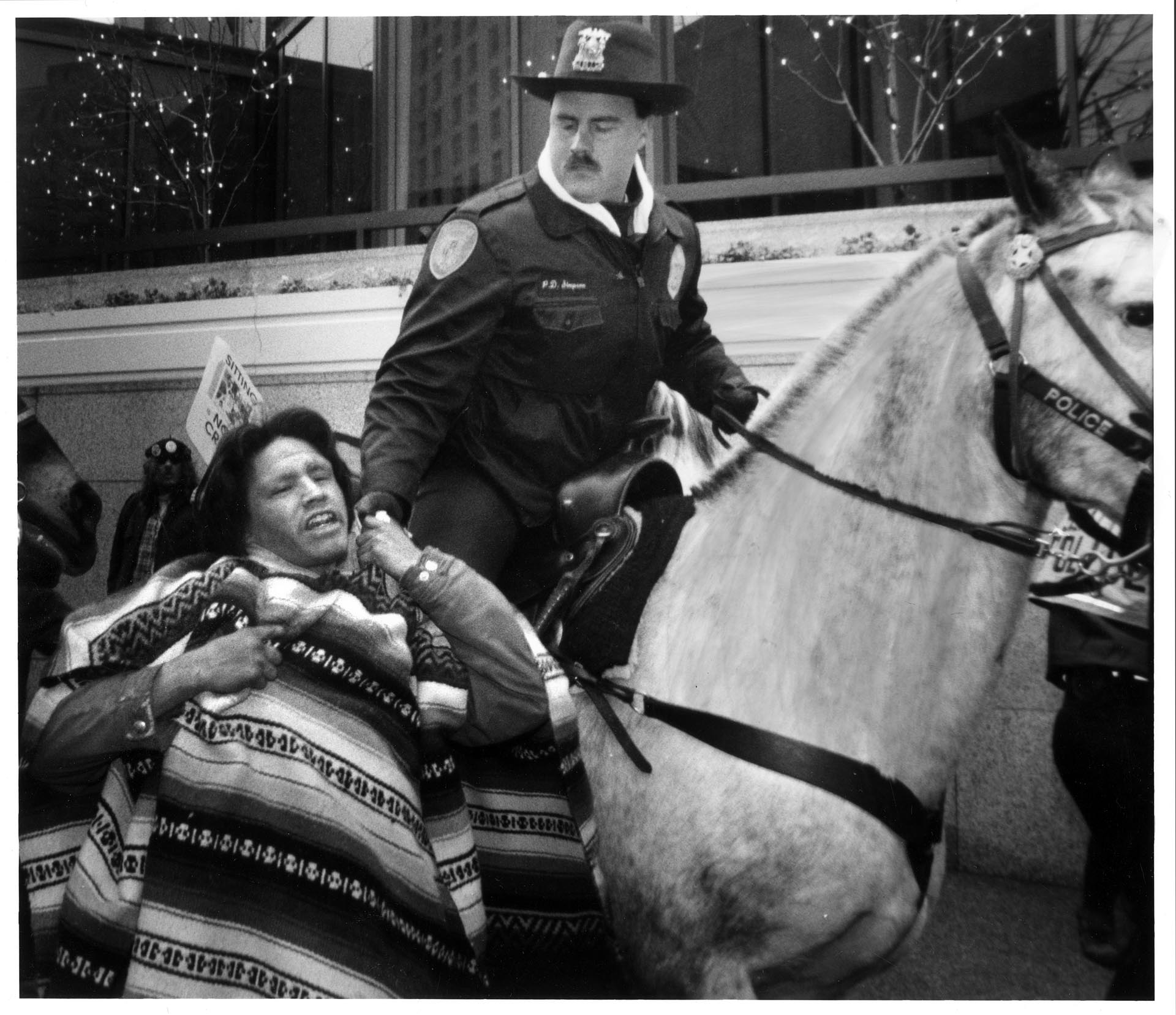 Image of Duane Glaesman being stopped by police officer during protest, November 18, 1993