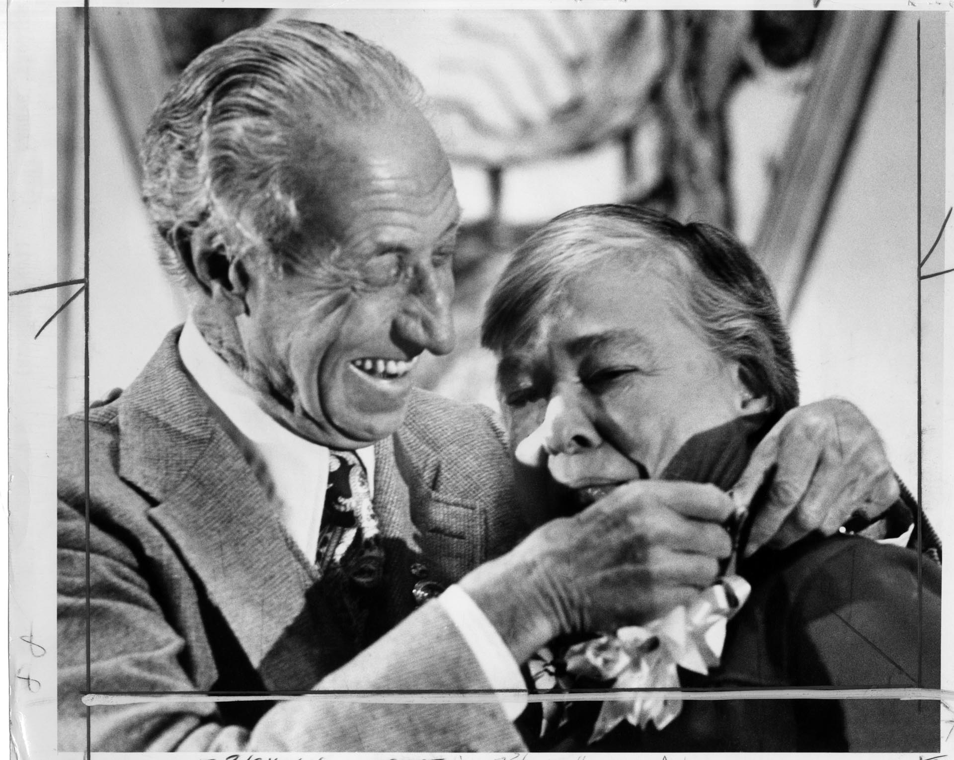 Image of Harry Bridges giving union badge to Dixy Lee Ray, Seattle, April 18, 1977