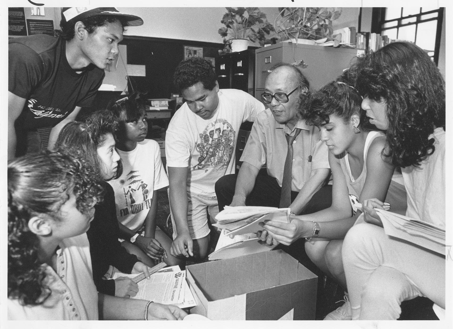 Image of Fred Cordova and students looking at Filipino American archive, Seattle, August31, 1987