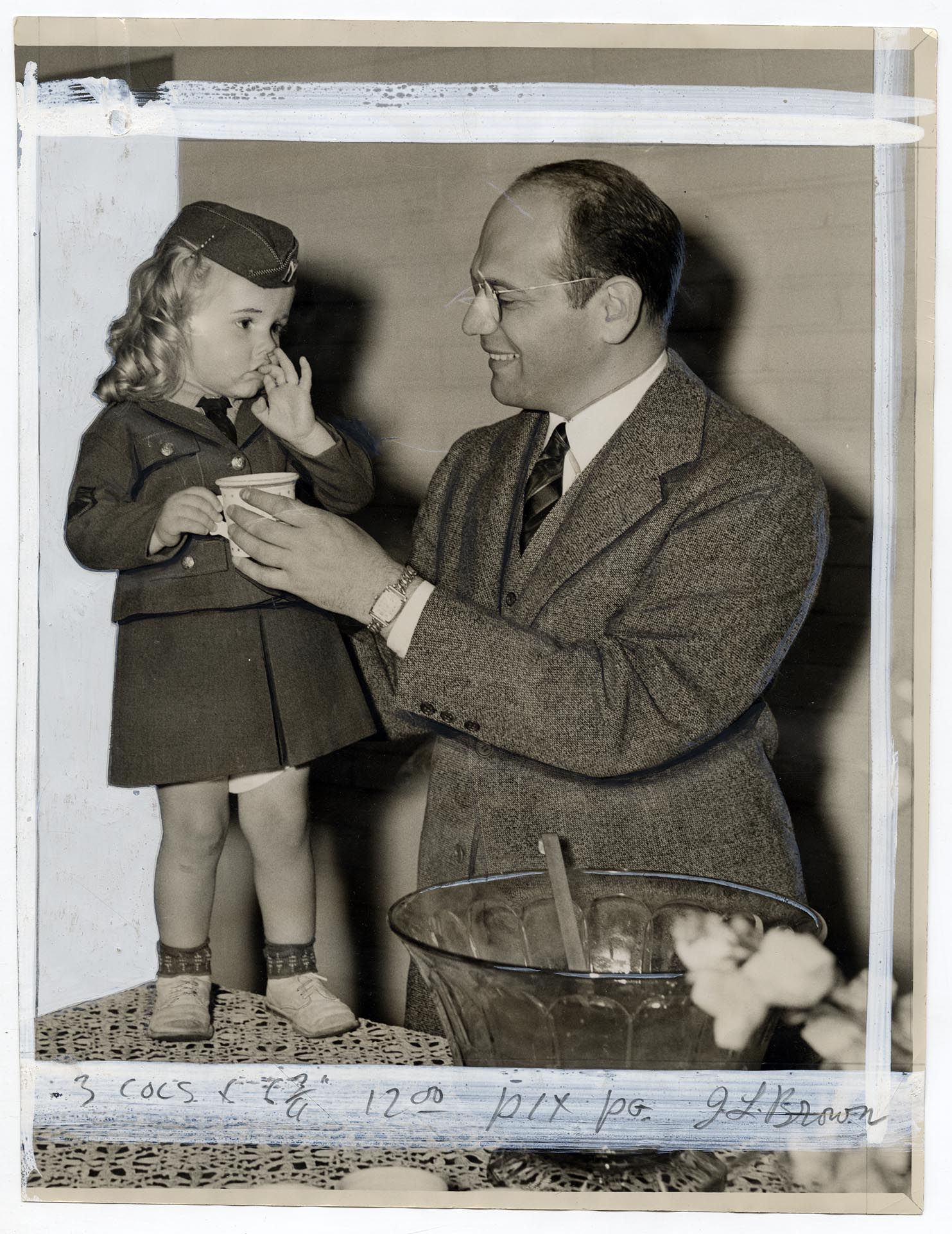 Image of Jesse Epstein receiving cup of punch from child after Yesler Terrace dedication, Seattle, June 16, 1942