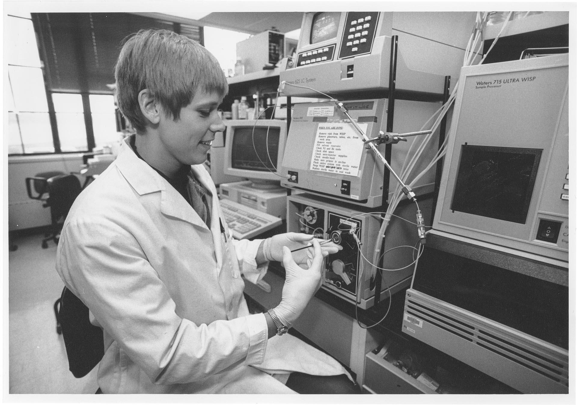Image of Dace Krasts working in lab at Immunex, Seattle, July 23, 1992