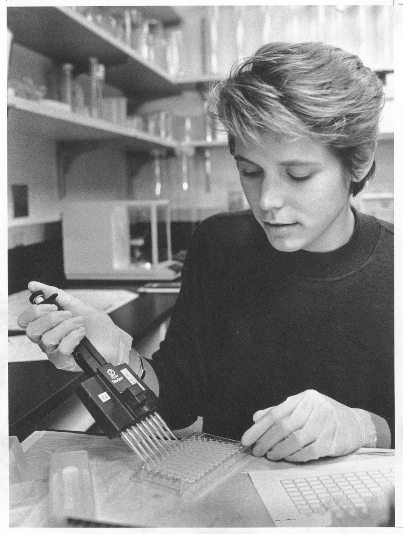 Image of Dace Krasts working in lab at Immunex, Seattle, December 13, 1990
