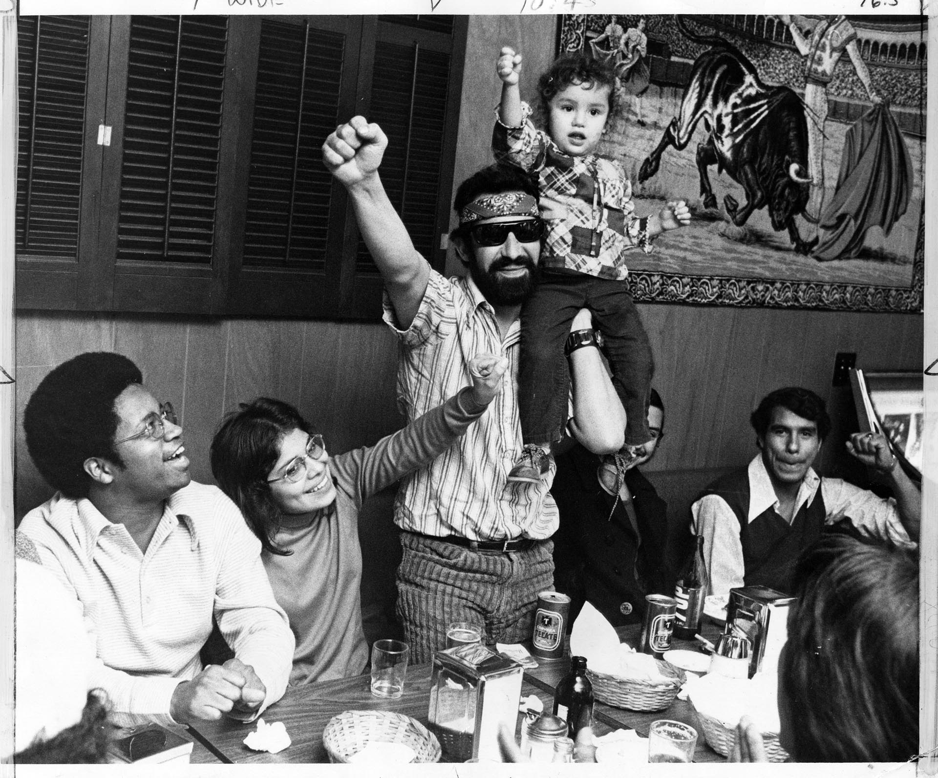 Image of Roberto Maestas, Larry Gossett and others celebrating in restaurant , Seattle, December 26, 1972