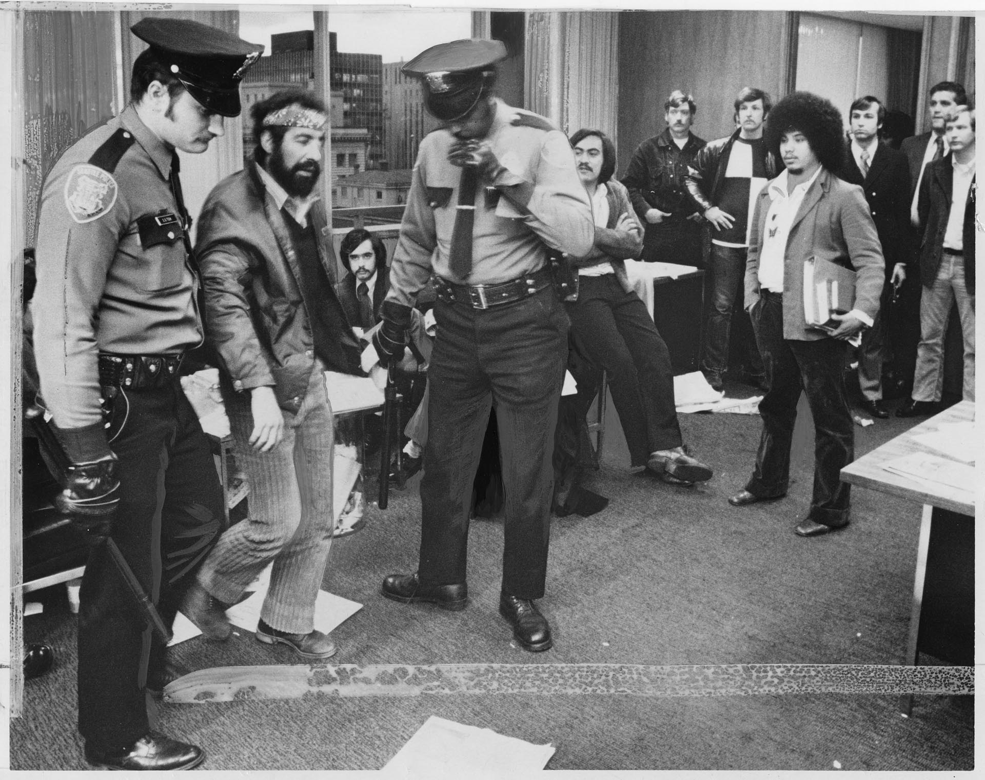 Image of Roberto Maestas being escorted out of mayor's office, Seattle, April 5, 1973