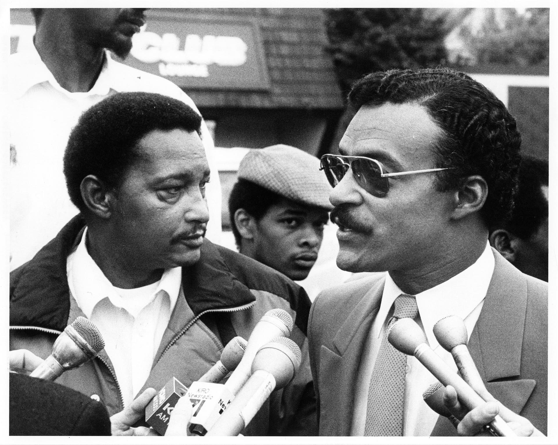 Image of Jim Mason and Eddie Rye, Jr. talking to press, Spetember 15, 1986
