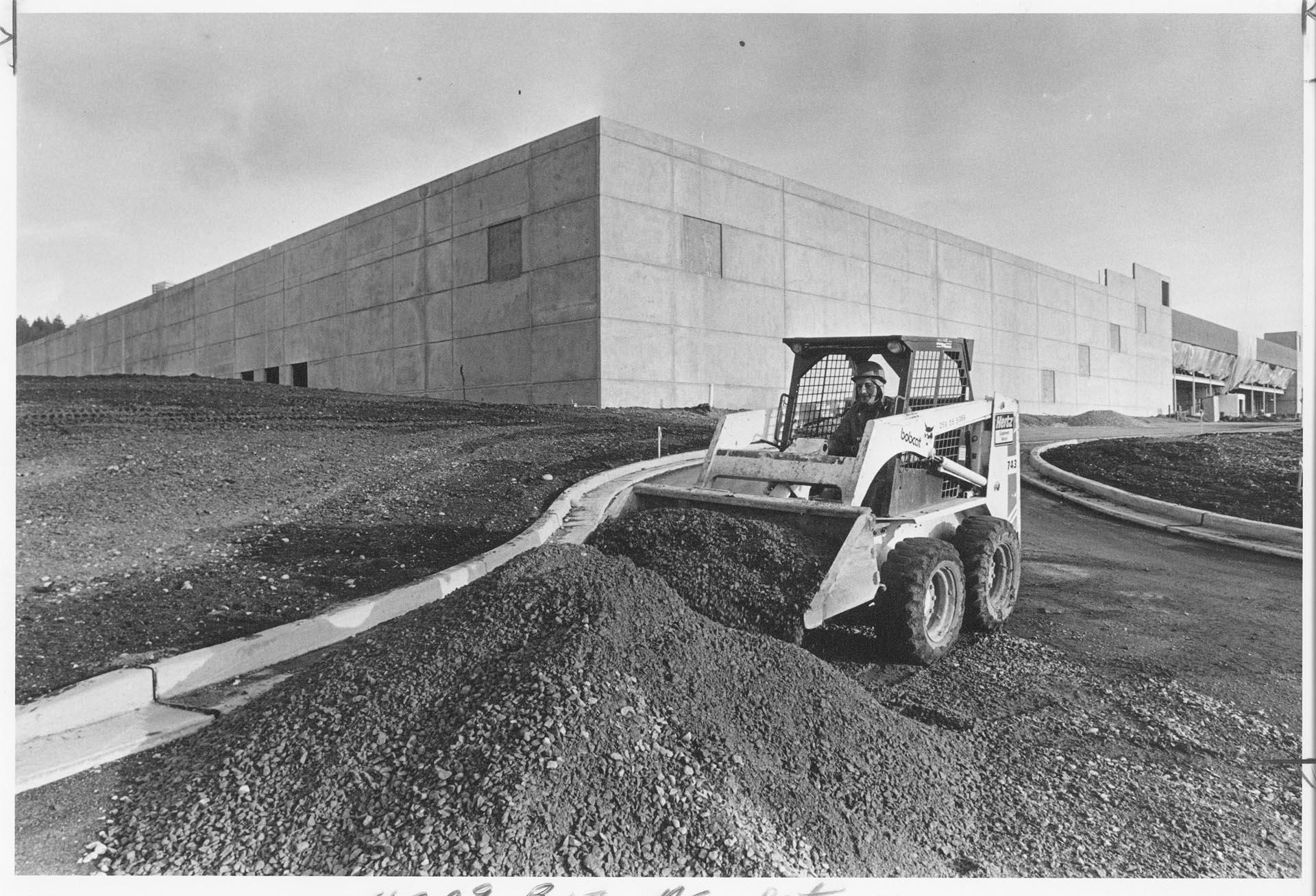 Image of Skid-steer loader clearing grounds for new Microsoft plant, Bothell, December 30, 1987