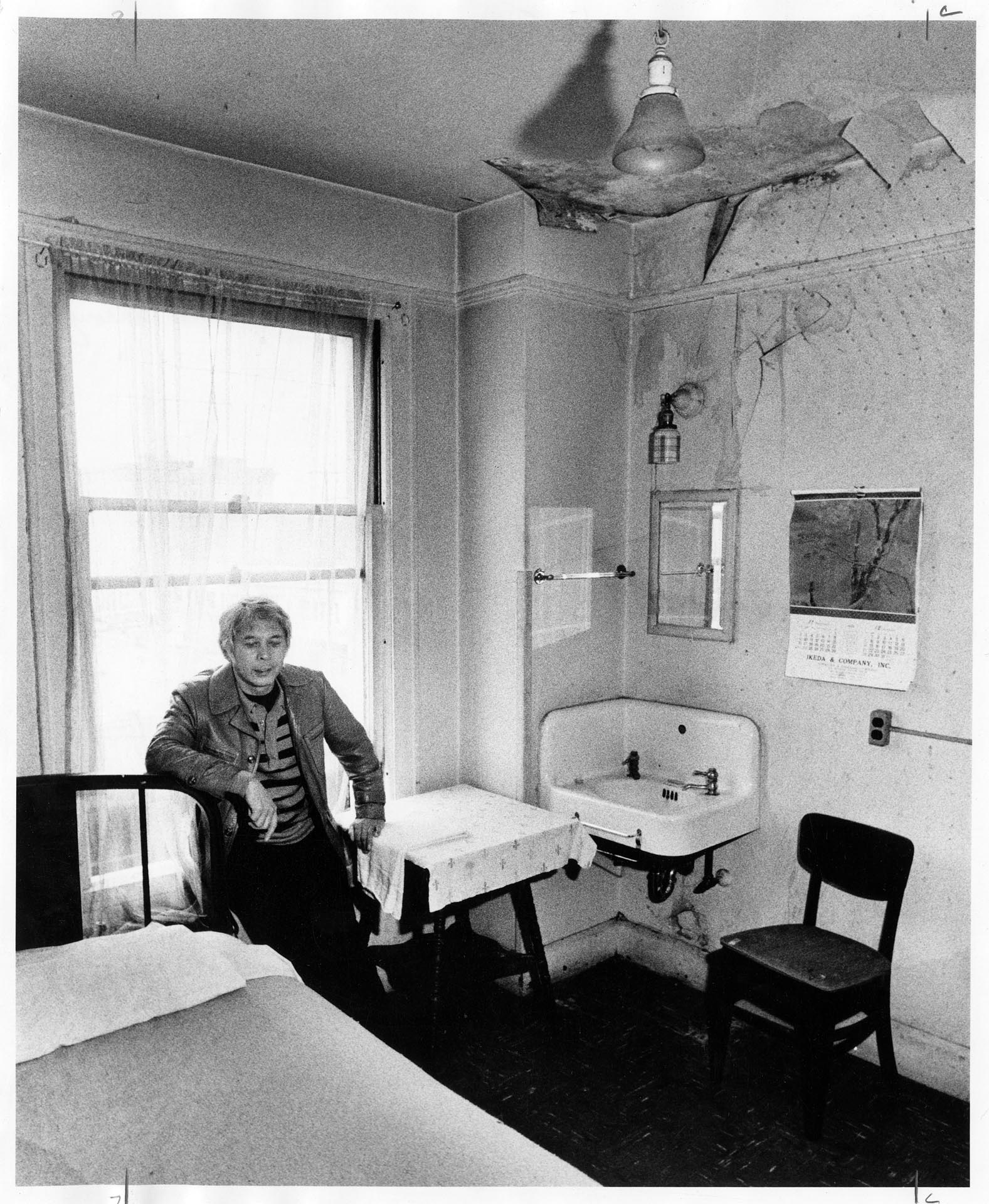 Image of Bob Santos visiting apartment in need of renovation, Seattle, December 15, 1980