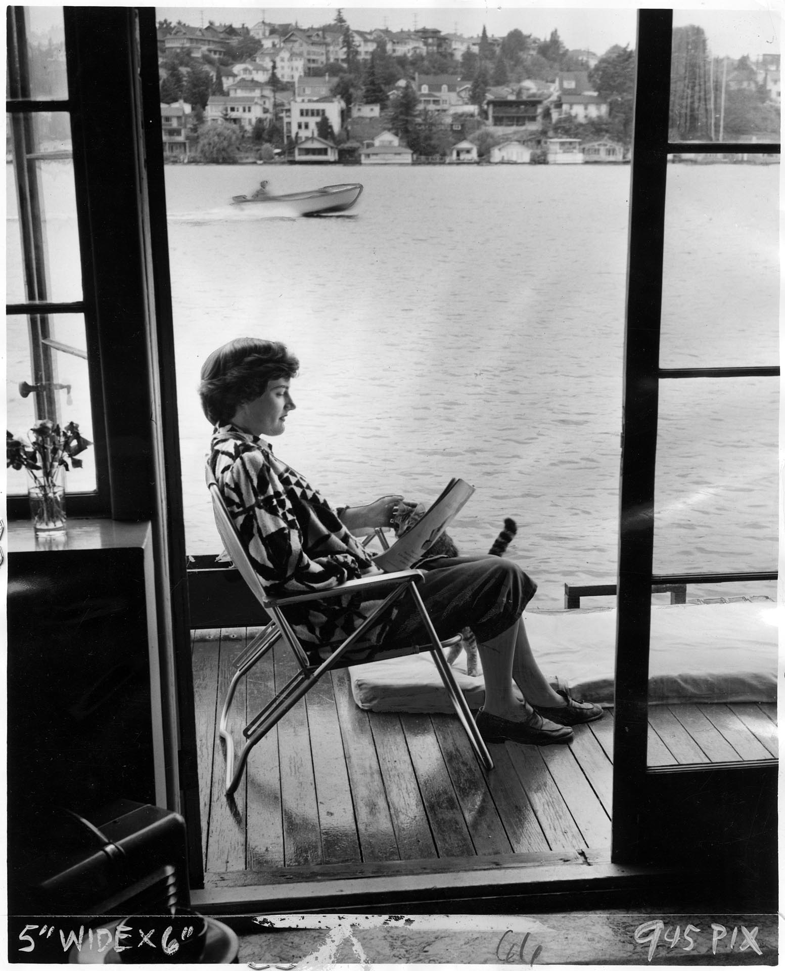 Image of Marjorie Lothrop reading on houseboat docked on Lake Union, Seattle, July 16, 1952