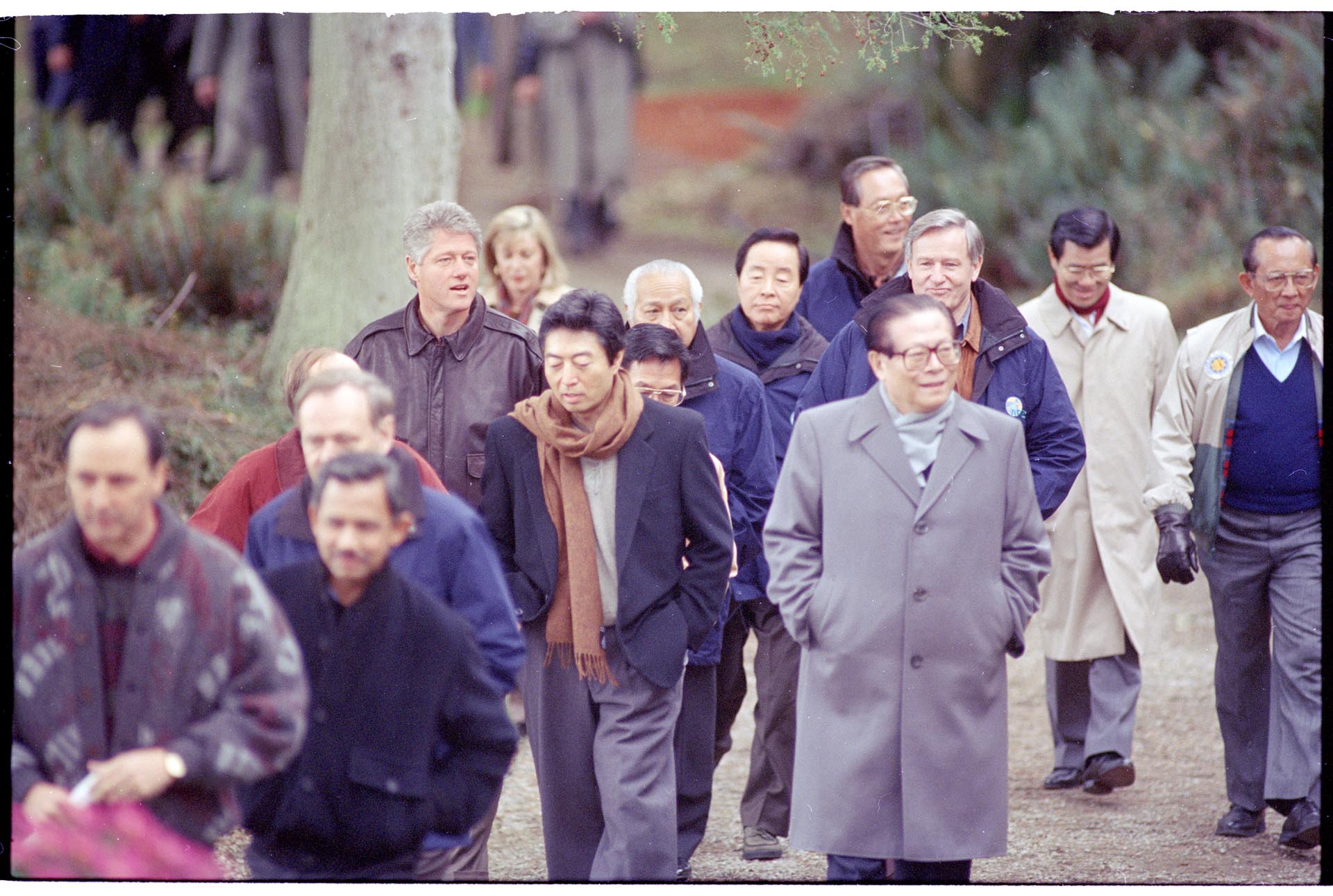 Image of APEC conference attendees walking to briefing area at Tillicum Village, Blake Island, November 20, 1993