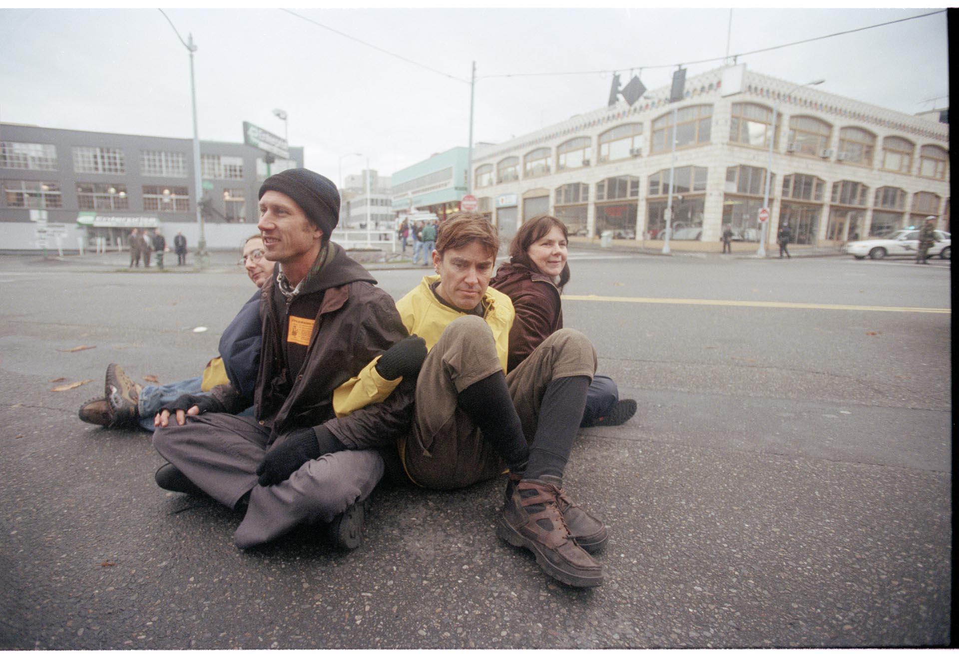 Image of Demonstrators sitting in street at WTO protest, Seattle, December 1, 1999