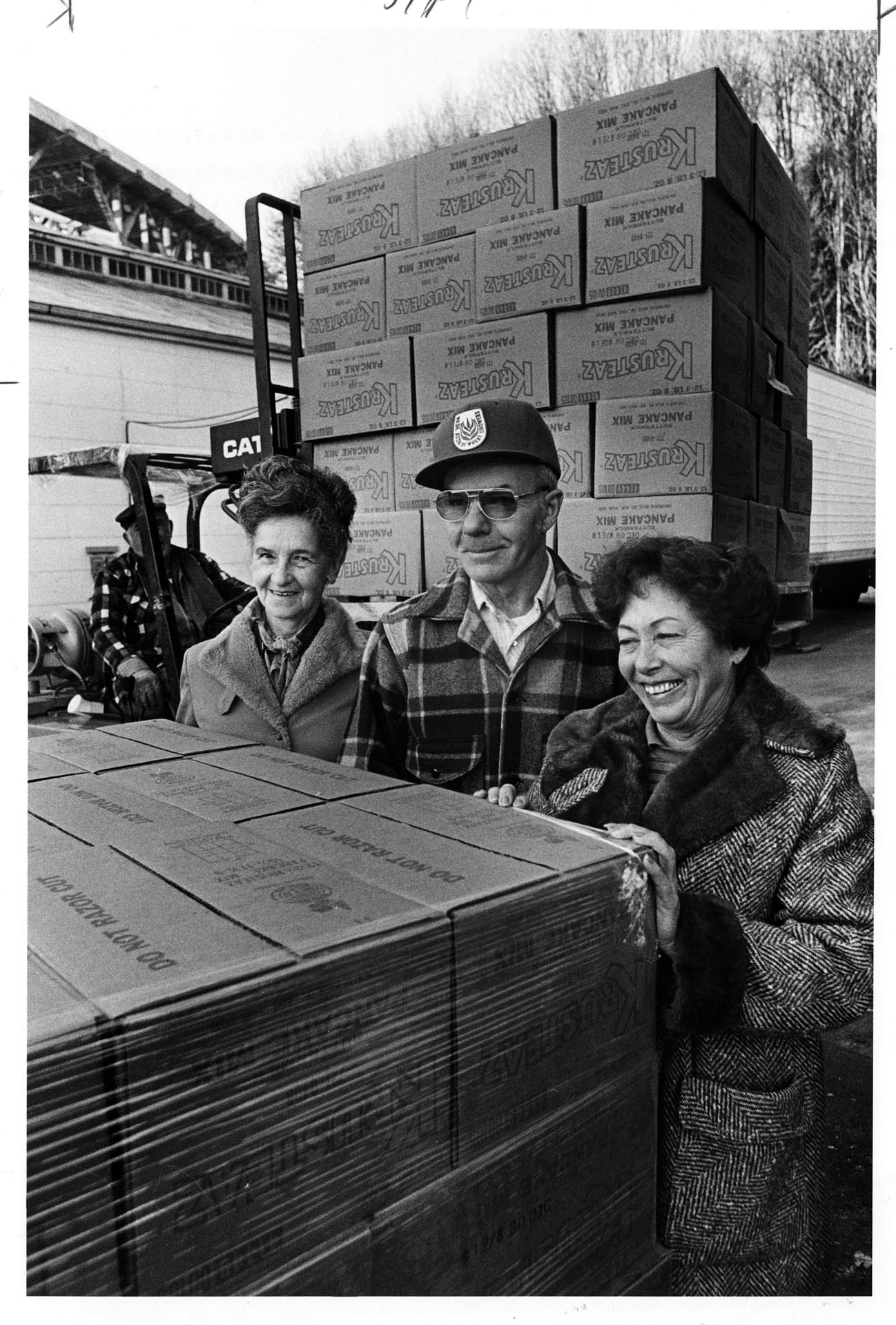 Image of Mary Lou Johnson, Howard Johnson, and Ruth Velozo with delivery at Northwest Harvest, Seattle, December 10, 1986