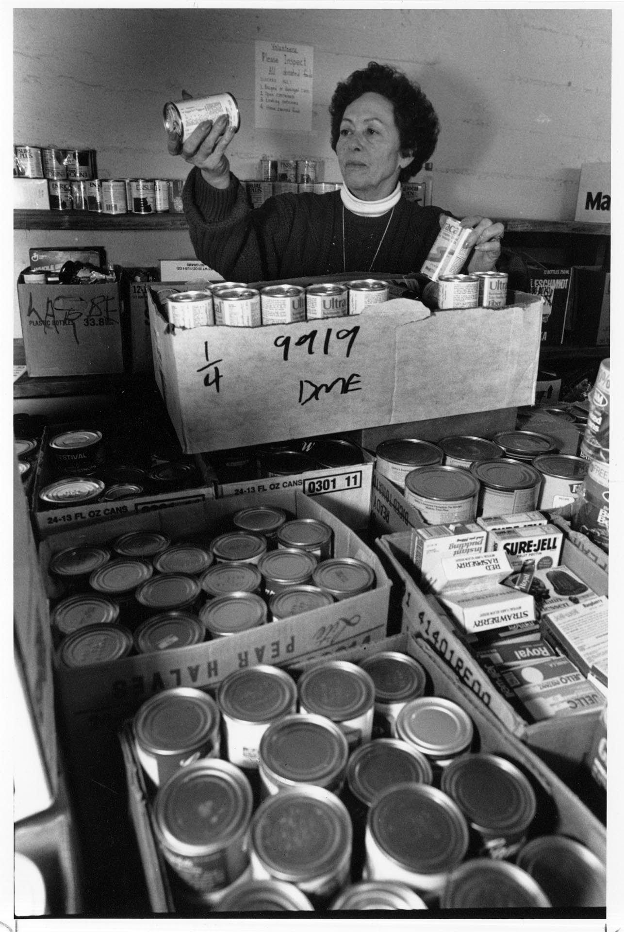 Image of Ruth Velozo checking cans of food at Northwest Harvest, Seattle, November 18, 1991