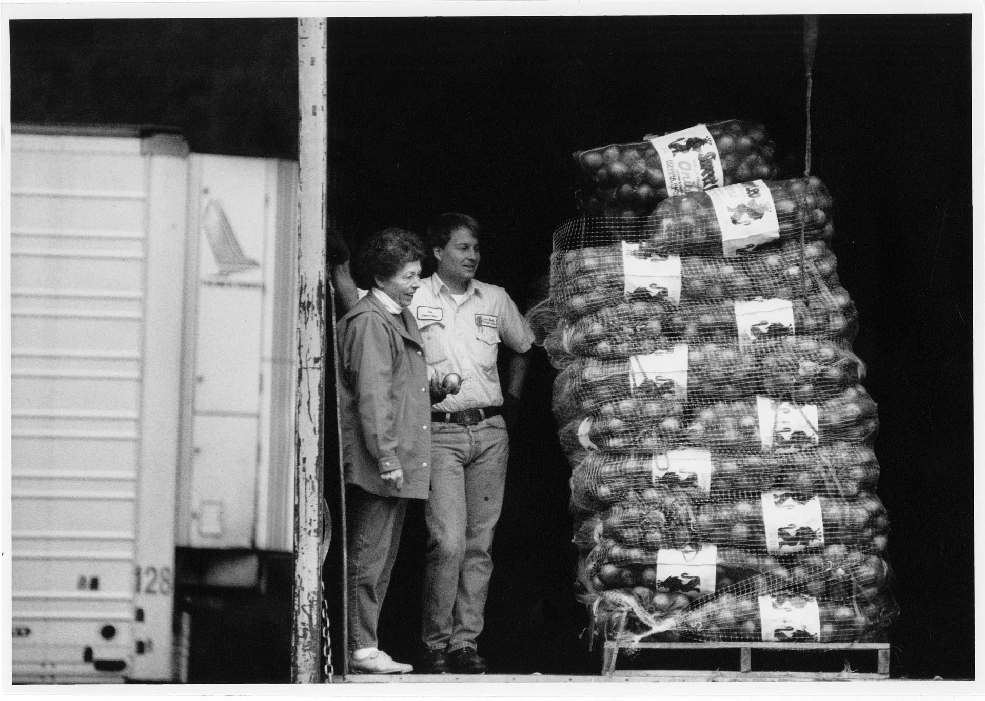 Image of Ruth Velozo and Bob Boogert watching the unloading of food donation at Northwest Harvest, Seattle, November 17, 1992