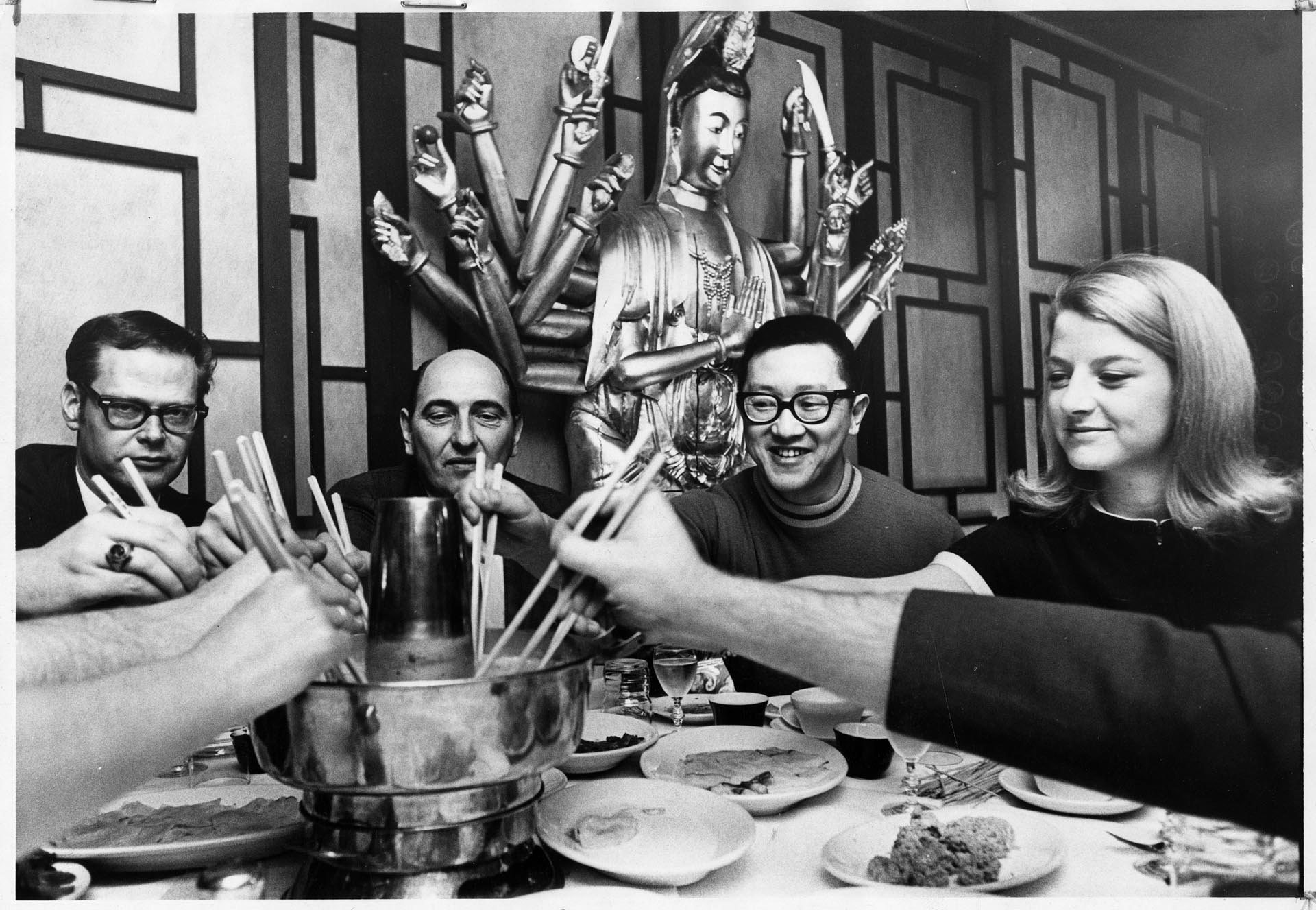 Image of Bob Petersen, Keith Craig, Ben Woo, and Jean Enerson eating Mongolian hot pot at Ruby Chow's, Seattle, April 27, 1969