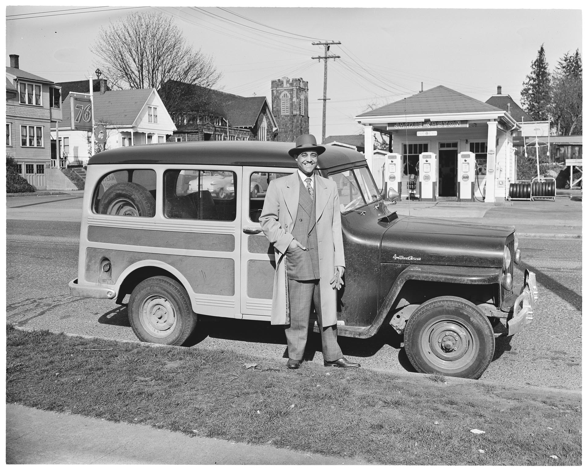 Image of Joe Smith standing in front of  his station wagon, Seattle, circa 1950