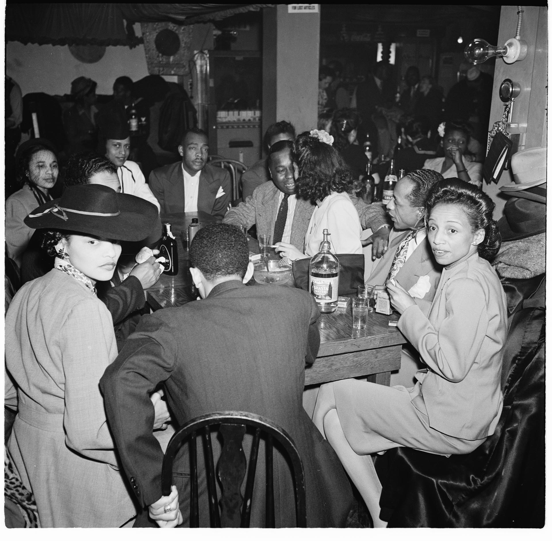 Image of Group at a table at the Basin Streen nightclub, Seattle, December 1945