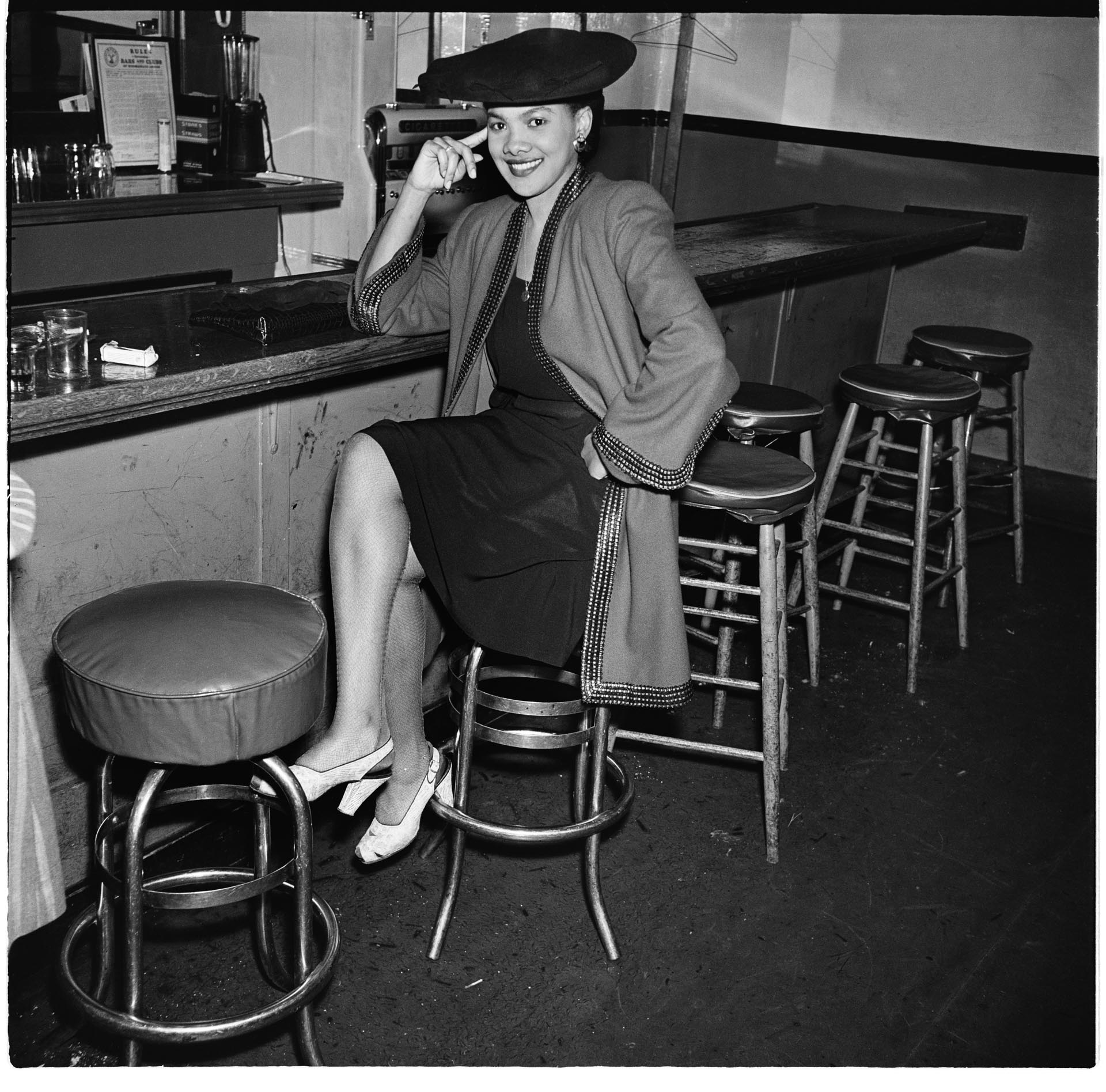 Image of Woman seated at the Black and Tan bar, Seattle, July 28, 1945