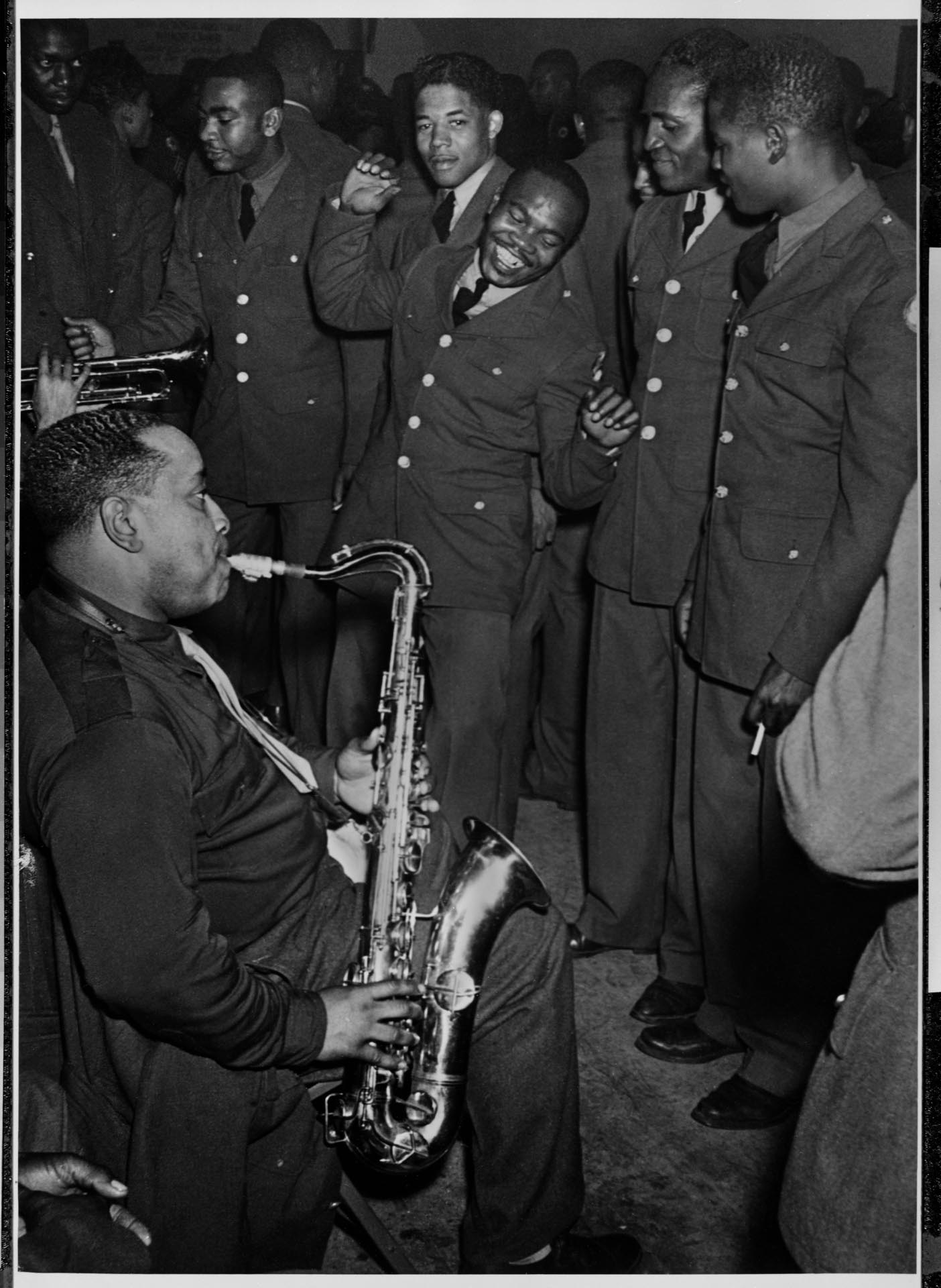 Image of Pete Peterson playing saxophone for a group of servicemen, Seattle, circa 1944