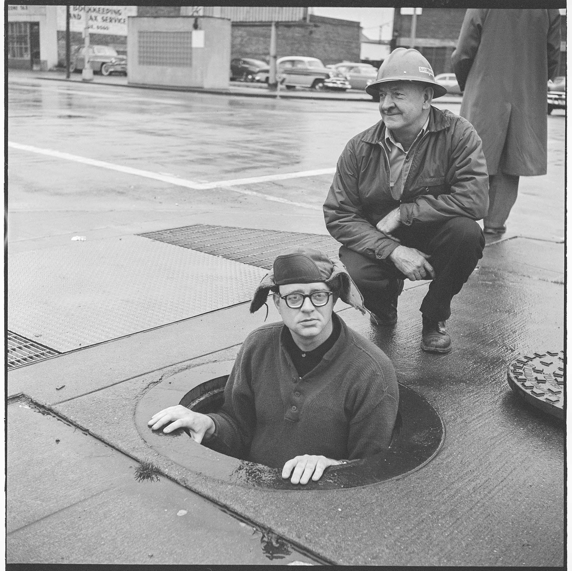Image of Battery Street Tunnel tenders at manhole, February 2, 1960