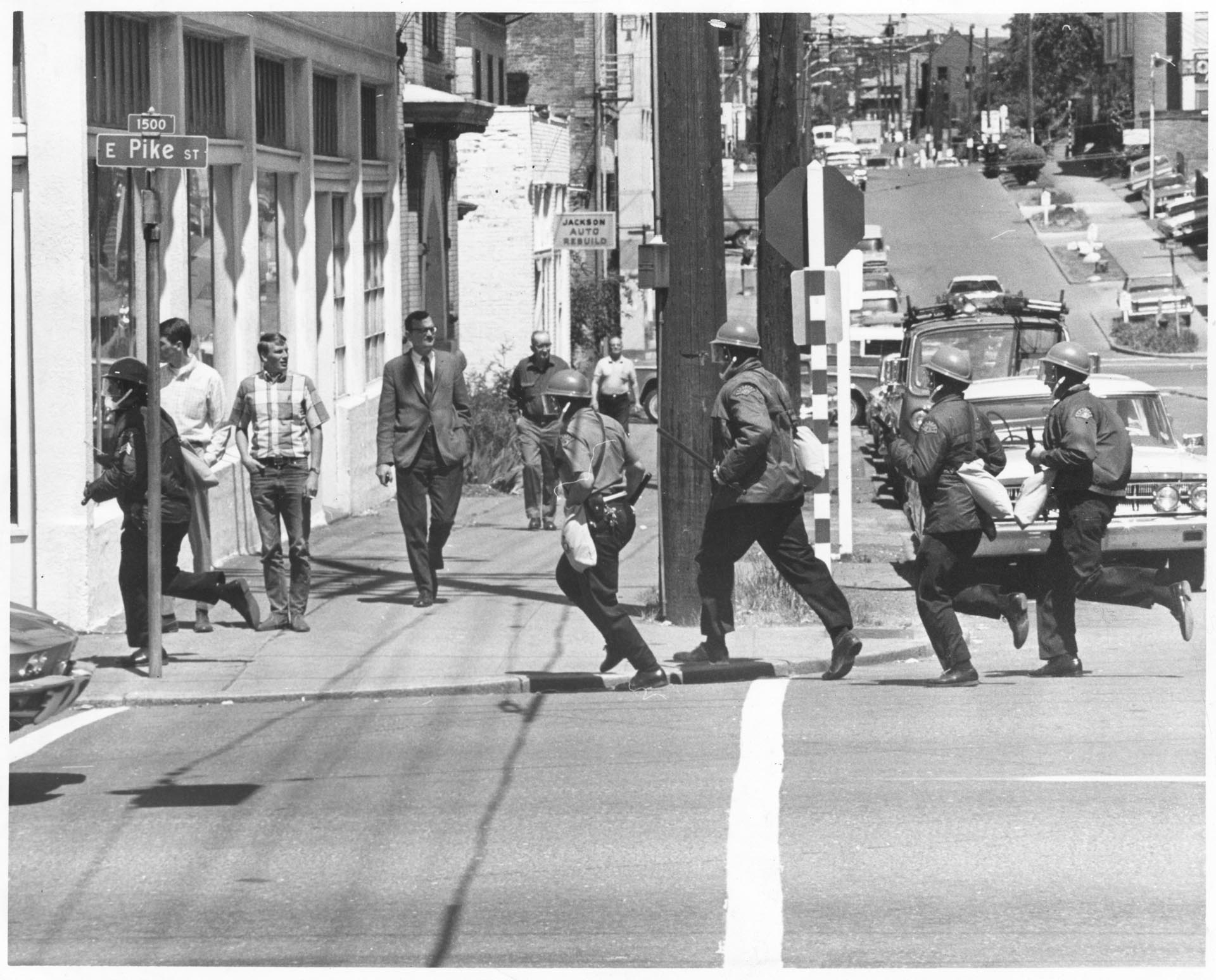 Image of Police running to demonstration at Summit Branch of Seattle Community College, May 23, 1969